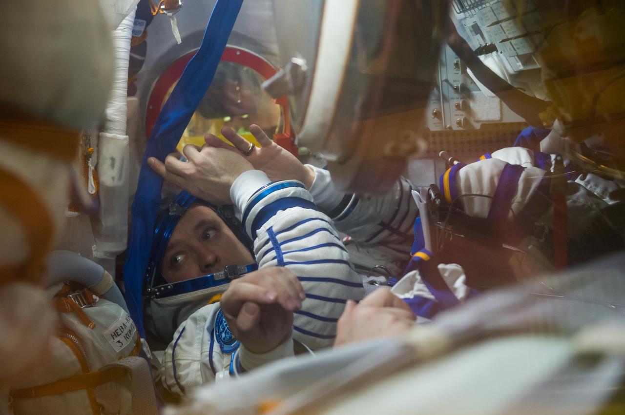 jsc2017e040291 (April 6, 2017) --- In the Integration Building at the Baikonur Cosmodrome in Kazakhstan, Expedition 51 crewmember Jack Fischer of NASA gestures from his seat in the Soyuz MS-04 spacecraft April 6 as part of pre-launch training preparations. Fischer and Fyodor Yurchikhin of the Russian Federal Space Agency (Roscosmos) will launch April 20 on the Soyuz MS-04 spacecraft for a four and a half month mission on the International Space Station. NASA/Gagarin Cosmonaut Training Center/Andrey Shelepin
