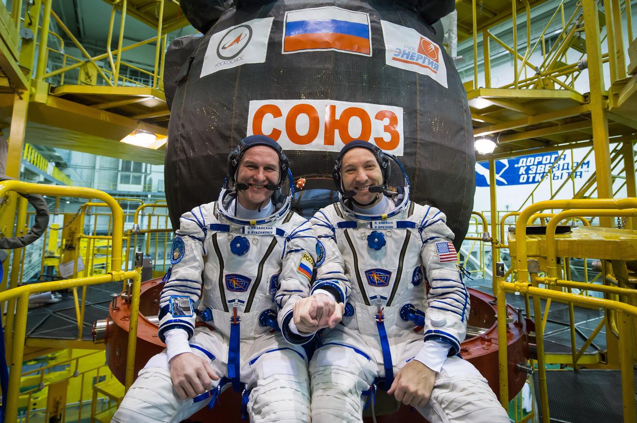 jsc2017e040292 (April 6, 2017) --- In the Integration Building at the Baikonur Cosmodrome in Kazakhstan, backup crewmembers Sergey Ryazanskiy of the Russian Federal Space Agency (Roscosmos, left) and Randy Bresnik of NASA (right) pose for pictures April 6 in front of the Soyuz MS-04 spacecraft as part of pre-launch preparations. Ryazanskiy and Bresnik are serving as backups to the prime crew, Jack Fischer of NASA and Fyodor Yurchikhin of Roscosmos, who will launch April 20 on the Soyuz MS-04 spacecraft for a four and a half month mission on the International Space Station. NASA/Gagarin Cosmonaut Training Center/Andrey Shelepin