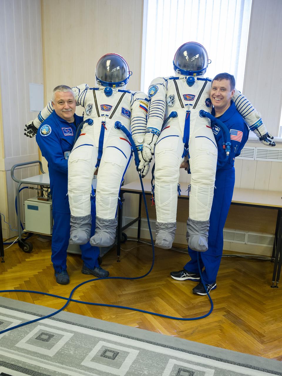 jsc2017e040293 (April 6, 2017) --- In the Integration Building at the Baikonur Cosmodrome in Kazakhstan, Expedition 51 crewmembers Fyodor Yurchikhin of the Russian Federal Space Agency (Roscosmos, left) and Jack Fischer of NASA (right) pose for pictures April 6 with their Russian Sokol launch and entry suits as part of pre-launch training preparations. Fischer and Yurchikhin will launch April 20 on the Soyuz MS-04 spacecraft for a four and a half month mission on the International Space Station. NASA/Gagarin Cosmonaut Training Center/Andrey Shelepin