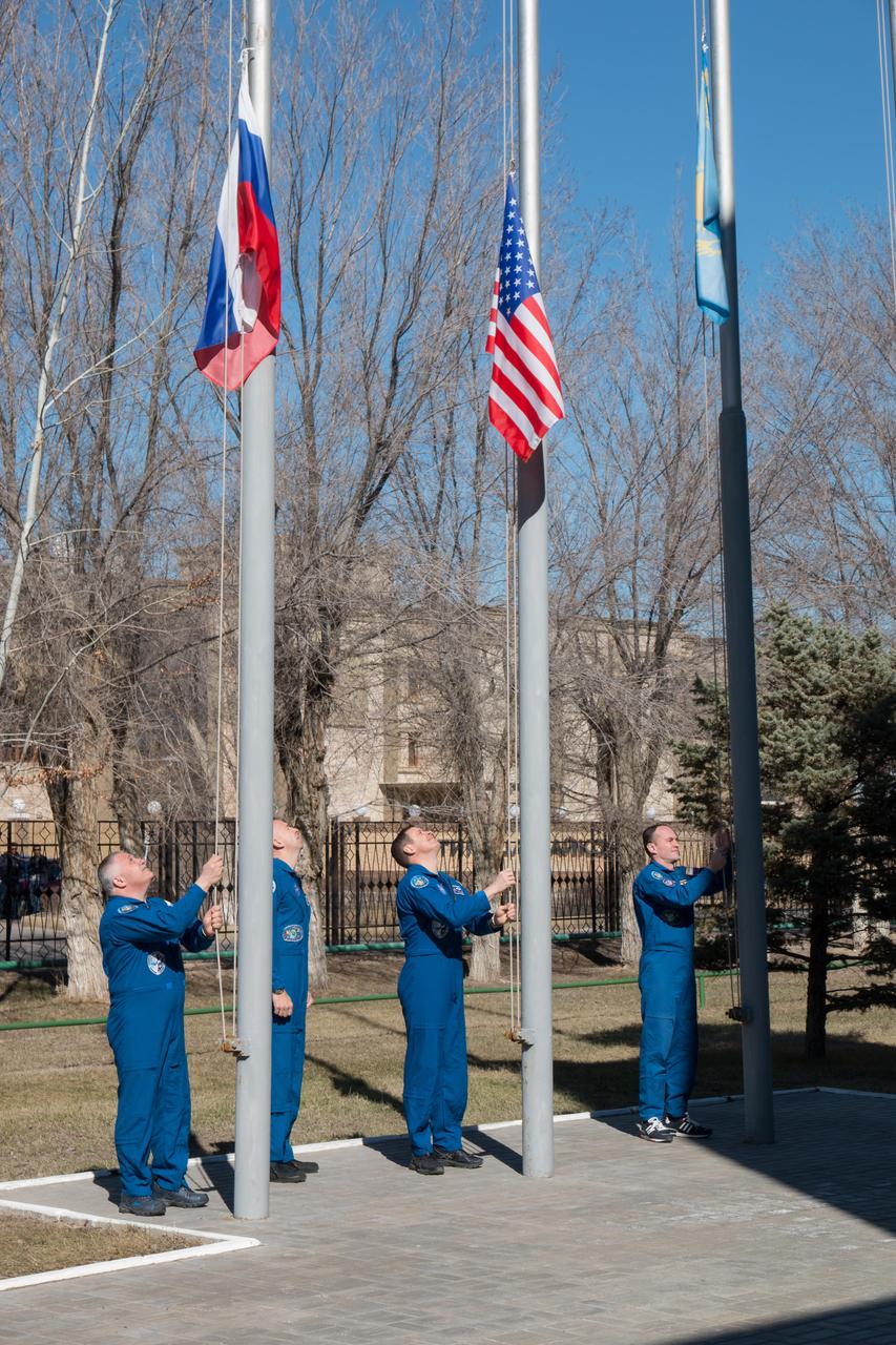 jsc2017e040341 (April 7, 2017) --- At the Cosmonaut Hotel crew quarters in Baikonur, Kazakhstan, the Expedition 51 prime and backup crewmembers raise the flags of Russia, the U.S. and Kazakhstan in traditional ceremonies April 7 as part of their pre-launch activities. From left to right are prime crewmember Fyodor Yurchikhin of the Russian Federal Space Agency (Roscosmos) raising the Russian flag, backup crewmember Randy Bresnik of NASA joining prime crewmember Jack Fischer of NASA to raise the American flag and backup crewmember Sergey Ryazanskiy of Roscosmos raising the Kazakh flag. Yurchikhin and Fischer will launch April 20 on the Soyuz MS-04 spacecraft from the Baikonur Cosmodrome for a four and a half month mission on the International Space Station. NASA/Victor Zelentsov