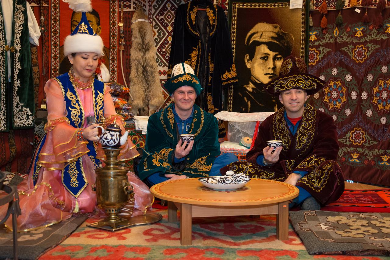 jsc2017e040350 (April 7, 2017) --- In Baikonur, Kazakhstan, Expedition 51 backup crewmembers Sergey Ryazanskiy of the Russian Federal Space Agency (Roscosmos, center) and Randy Bresnik of NASA (right) sample local tea in a traditional Kazakh “yurt” or tent April 7 while wearing traditional Kazakh robes and hats. They are serving as backups to Fyodor Yurchikhin of Roscosmos and Jack Fischer of NASA, who will launch April 20 on the Soyuz MS-04 spacecraft from the Baikonur Cosmodrome for a four and a half month mission on the International Space Station. NASA/Victor Zelentsov