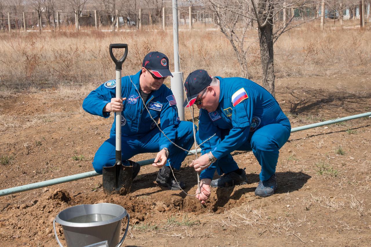 jsc2017e043076 (April 13, 2017) --- At the Cosmonaut Hotel crew quarters in Baikonur, Kazakhstan, Expedition 51 crewmember Fyodor Yurchikhin of the Russian Federal Space Agency (Roscosmos, right) helps crewmate Jack Fischer of NASA (left) plant a tree in Fischer’s name April 13 as part of traditional pre-launch activities. Fischer and Yurchikhin will liftoff April 20 from the Baikonur Cosmodrome on the Soyuz MS-04 spacecraft for a four and a half month mission on the International Space Station. NASA/Victor Zelentsov