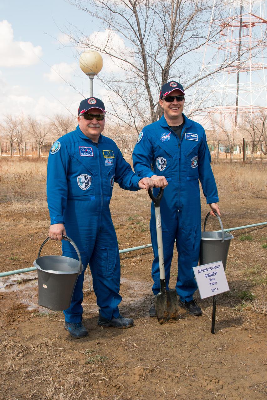 jsc2017e043078 (April 13, 2017) --- At the Cosmonaut Hotel crew quarters in Baikonur, Kazakhstan, Expedition 51 crewmembers Fyodor Yurchikhin of the Russian Federal Space Agency (Roscosmos, left) and Jack Fischer of NASA (right) pose for pictures after planting a tree in Fischer’s name April 13 as part of traditional pre-launch activities. Fischer and Yurchikhin will liftoff April 20 from the Baikonur Cosmodrome on the Soyuz MS-04 spacecraft for a four and a half month mission on the International Space Station. NASA/Victor Zelentsov