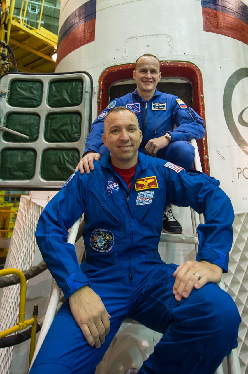 jsc2017e043844 (April 14, 2017) --- In the Integration Facility at the Baikonur Cosmodrome in Kazakhstan, Expedition 51 backup crewmembers Randy Bresnik of NASA (bottom) and Sergey Ryazanskiy of the Russian Federal Space Agency (Roscosmos, top) pose for pictures April 14 during a final inspection of the Soyuz MS-04 spacecraft. They are serving as backups to Fyodor Yurchikhin of Roscosmos and Jack Fischer of NASA, who will launch April 20 on the Soyuz MS-04 spacecraft for a four and a half month mission on the International Space Station. Credit: NASA/Gagarin Cosmonaut Training Center/Andrey Shelepin