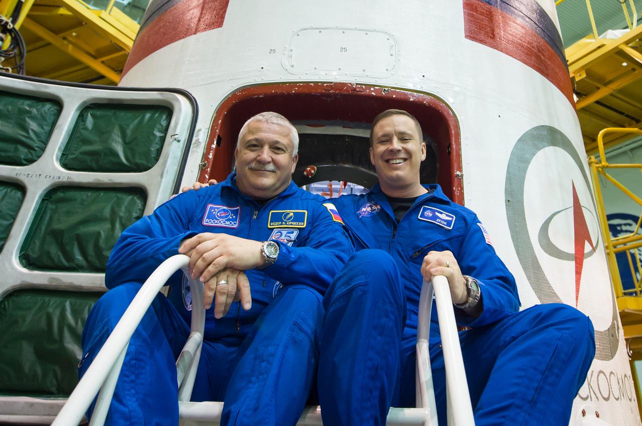 jsc2017e043846 (April 14, 2017) --- In the Integration Facility at the Baikonur Cosmodrome in Kazakhstan, Expedition 51 crewmembers Fyodor Yurchikhin of the Russian Federal Space Agency (Roscosmos, left) and Jack Fischer of NASA (right) pose for pictures April 14 during a final inspection of the Soyuz MS-04 spacecraft. They will launch April 20 on the Soyuz MS-04 spacecraft for a four and a half month mission on the International Space Station. Credit: NASA/Gagarin Cosmonaut Training Center/Andrey Shelepin