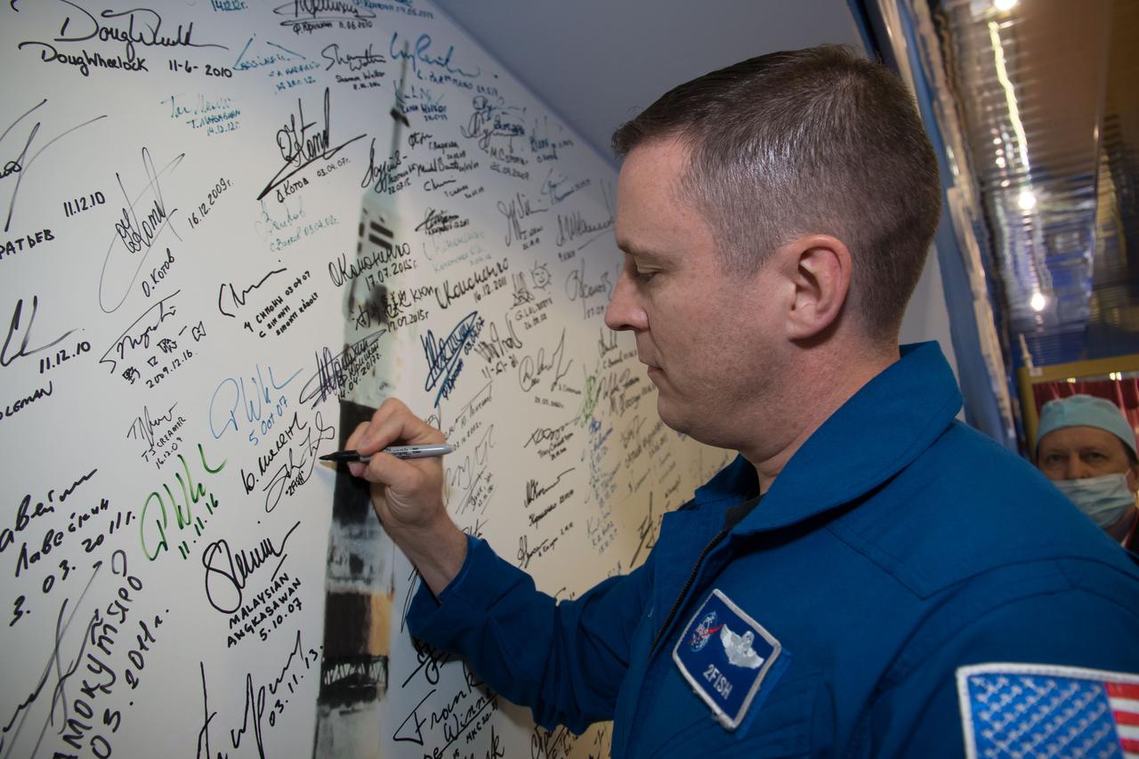 jsc2017e043852 (April 14, 2017) --- At the Baikonur Cosmodrome Museum in Kazakhstan, Expedition 51 crewmember Jack Fischer of NASA signs a wall mural April 14 during a traditional tour of the facility. Fischer and Fyodor Yurchikhin of the Russian Federal Space Agency (Roscosmos) will launch April 20 on the Soyuz MS-04 spacecraft for a four and a half month mission on the International Space Station. Credit: NASA/Victor Zelentsov
