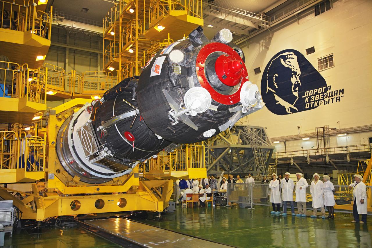 jsc2017e044352 (April 12, 2017) --- In the Integration Facility at the Baikonur Cosmodrome in Kazakhstan, the Soyuz MS-04 spacecraft is lowered from its test stand to be encapsulated into the upper stage of a Soyuz booster rocket April 12 as technicians look on. The operation took place on the 56th anniversary of the launch of Yuri Gagarin from Baikonur to become the first human to fly in space. Expedition 51 crewmembers Fyodor Yurchikhin of the Russian Federal Space Agency (Roscosmos) and Jack Fischer of NASA will launch April 20 on the Soyuz MS-04 spacecraft from Baikonur for a four and a half month mission on the International Space Station. Photo Credit: (Roscosmos)