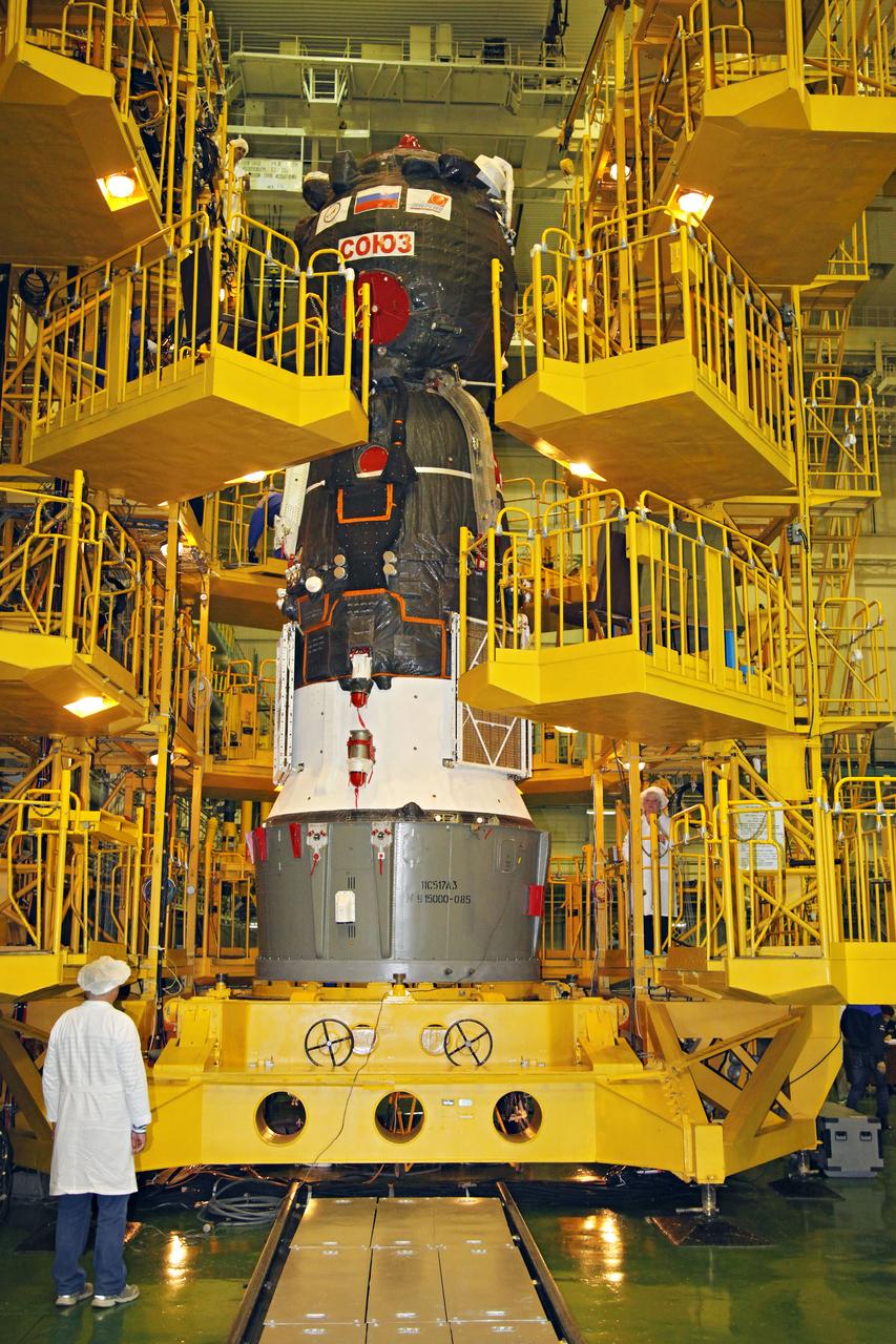 jsc2017e044353 (April 12, 2017) --- In the Integration Facility at the Baikonur Cosmodrome in Kazakhstan, the Soyuz MS-04 spacecraft is pictured on its test stand before being encapsulated into the upper stage of a Soyuz booster rocket April 12 as technicians look on. The operation took place on the 56th anniversary of the launch of Yuri Gagarin from Baikonur to become the first human to fly in space. Expedition 51 crewmembers Fyodor Yurchikhin of the Russian Federal Space Agency (Roscosmos) and Jack Fischer of NASA will launch April 20 on the Soyuz MS-04 spacecraft from Baikonur for a four and a half month mission on the International Space Station. Photo Credit: (Roscosmos)
