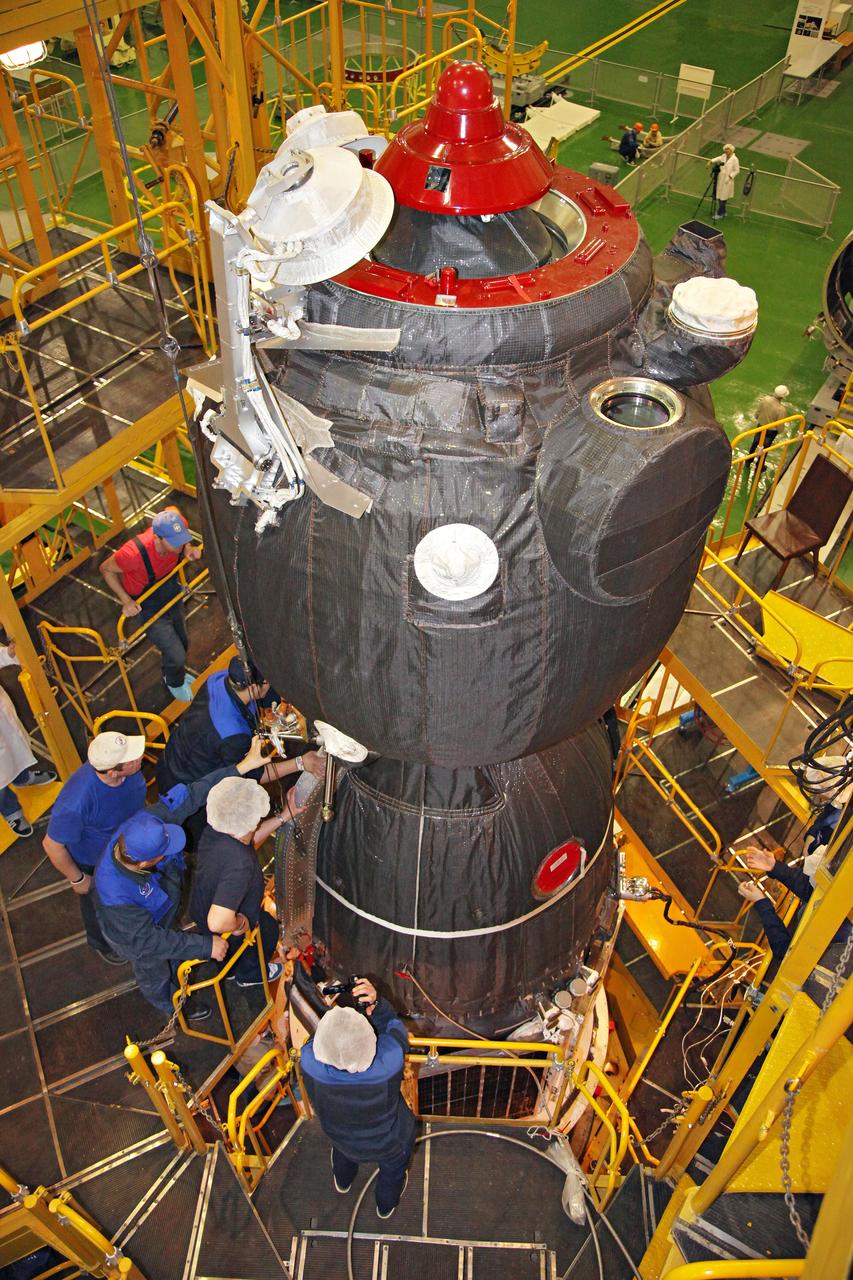 jsc2017e044354 (April 12, 2017) --- In the Integration Facility at the Baikonur Cosmodrome in Kazakhstan, technicians put the final touches on the Soyuz MS-04 spacecraft before its encapsulation into the upper stage of a Soyuz booster rocket April 12. The operation took place on the 56th anniversary of the launch of Yuri Gagarin from Baikonur to become the first human to fly in space. Expedition 51 crewmembers Fyodor Yurchikhin of the Russian Federal Space Agency (Roscosmos) and Jack Fischer of NASA will launch April 20 on the Soyuz MS-04 spacecraft from Baikonur for a four and a half month mission on the International Space Station. Photo Credit: (Roscosmos)