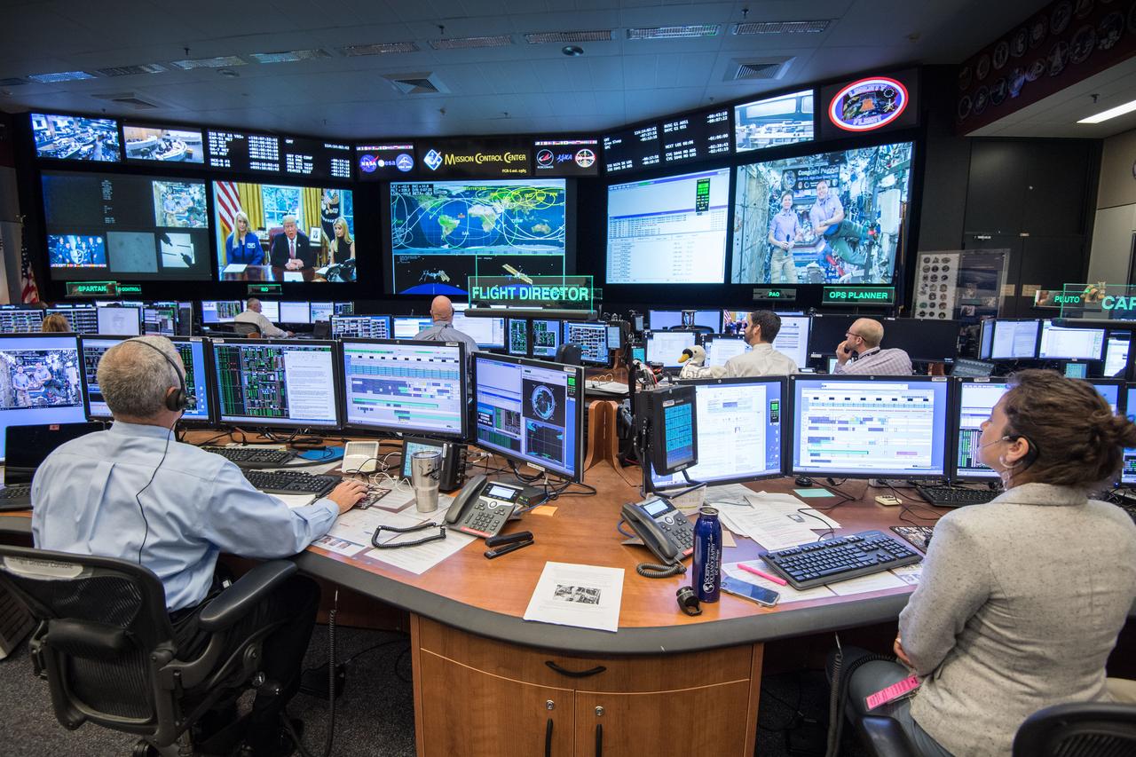 jsc2017e049157 (April 24, 2017) --- Flight Director Brian Smith, Capcom Astronaut Jessica Meir along with Astronaut Jeff Williams monitor activities in Mission Control as President Donald Trump, First Daughter Ivanka Trump and NASA astronaut Kate Rubins make a special Earth-to-space call from the Oval Office to personally congratulate NASA astronaut Peggy Whitson for her record-breaking stay aboard the International Space Station. (Photo Credit: NASA/Robert Markowitz)
