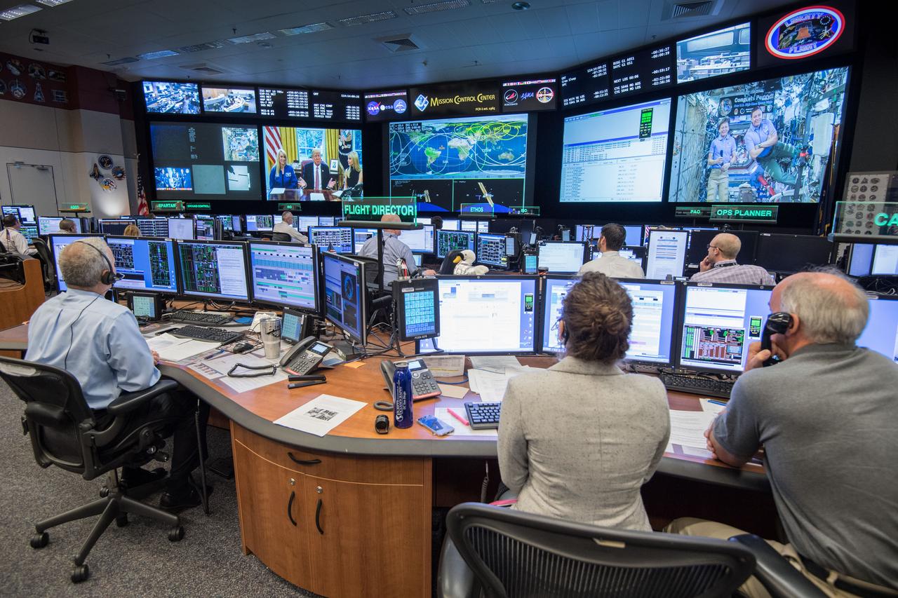 jsc2017e049160 (April 24, 2017) --- Flight Director Brian Smith, Capcom Astronaut Jessica Meir along with Astronaut Jeff Williams monitor activities in Mission Control as President Donald Trump, First Daughter Ivanka Trump and NASA astronaut Kate Rubins make a special Earth-to-space call from the Oval Office to personally congratulate NASA astronaut Peggy Whitson for her record-breaking stay aboard the International Space Station. (Photo Credit: NASA/Robert Markowitz)