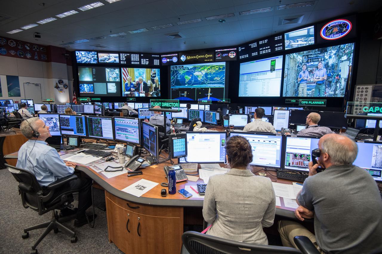 jsc2017e049163 (April 24, 2017) --- Flight Director Brian Smith, Capcom Astronaut Jessica Meir along with Astronaut Jeff Williams monitor activities in Mission Control as President Donald Trump, First Daughter Ivanka Trump and NASA astronaut Kate Rubins make a special Earth-to-space call from the Oval Office to personally congratulate NASA astronaut Peggy Whitson for her record-breaking stay aboard the International Space Station. (Photo Credit: NASA/Robert Markowitz)