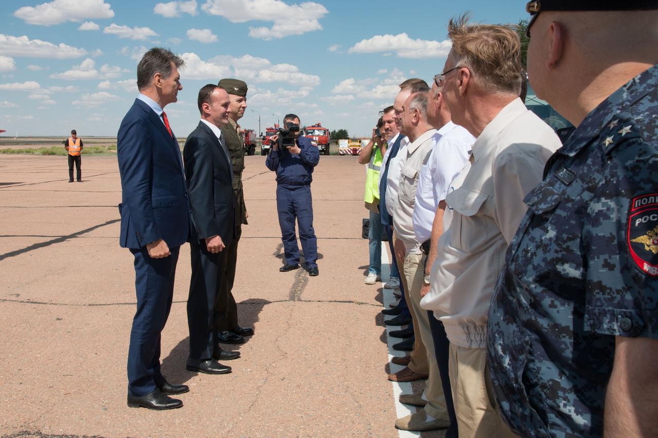 jsc2017e095964 (July 16, 2017) --- Expedition 52-53 prime crewmembers Paolo Nespoli of the European Space Agency (far left), Sergey Ryazanskiy of the Russian Federal Space Agency (Roscosmos, left and center) and Randy Bresnik of NASA (left and right) are greeted by Russian space officials after their arrival at their launch site in Baikonur, Kazakhstan July 16 following a flight from their training base in Star City, Russia. Ryazanskiy, Bresnik and Nespoli will launch July 28 from the Baikonur Cosmodrome aboard the Soyuz MS-05 spacecraft for a five-month mission on the International Space Station. Credit: NASA/Victor Zelentsov