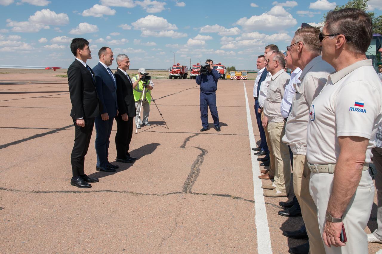 jsc2017e095965 (July 16, 2017) --- Expedition 52-53 backup crewmembers Norishige Kanai of the Japan Aerospace Exploration Agency (JAXA, far left), Alexander Misurkin of the Russian Federal Space Agency (Roscosmos, left and center) and Mark Vande Hei of NASA (left and right) are greeted by Russian space officials after their arrival at their launch site in Baikonur, Kazakhstan July 16 following a flight from their training base in Star City, Russia. The prime crew, Sergey Ryazanskiy of Roscosmos, Randy Bresnik of NASA and Paolo Nespoli of the European Space Agency will launch July 28 from the Baikonur Cosmodrome aboard the Soyuz MS-05 spacecraft for a five-month mission on the International Space Station. Credit: NASA/Victor Zelentsov