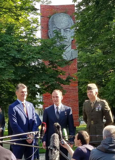 jsc2017e095968 (July 16, 2017) --- With a tree-shrouded statue of Vladimir Lenin serving as a backdrop at the Gagarin Cosmonaut Training Center in Star City, Russia, Expedition 52-53 crewmember Sergey Ryazanskiy of the Russian Federal Space Agency (Roscosmos, center) answers a reporter’s question July 16 as his crewmates, Paolo Nespoli of the European Space Agency (left) and Randy Bresnik of NASA (right) look on. The trio flew to the Baikonur Cosmodrome in Kazakhstan for final pre-launch training for their launch July 28 on the Soyuz MS-05 spacecraft and a five-month mission on the International Space Station. Credit: NASA/Beth Weissinger