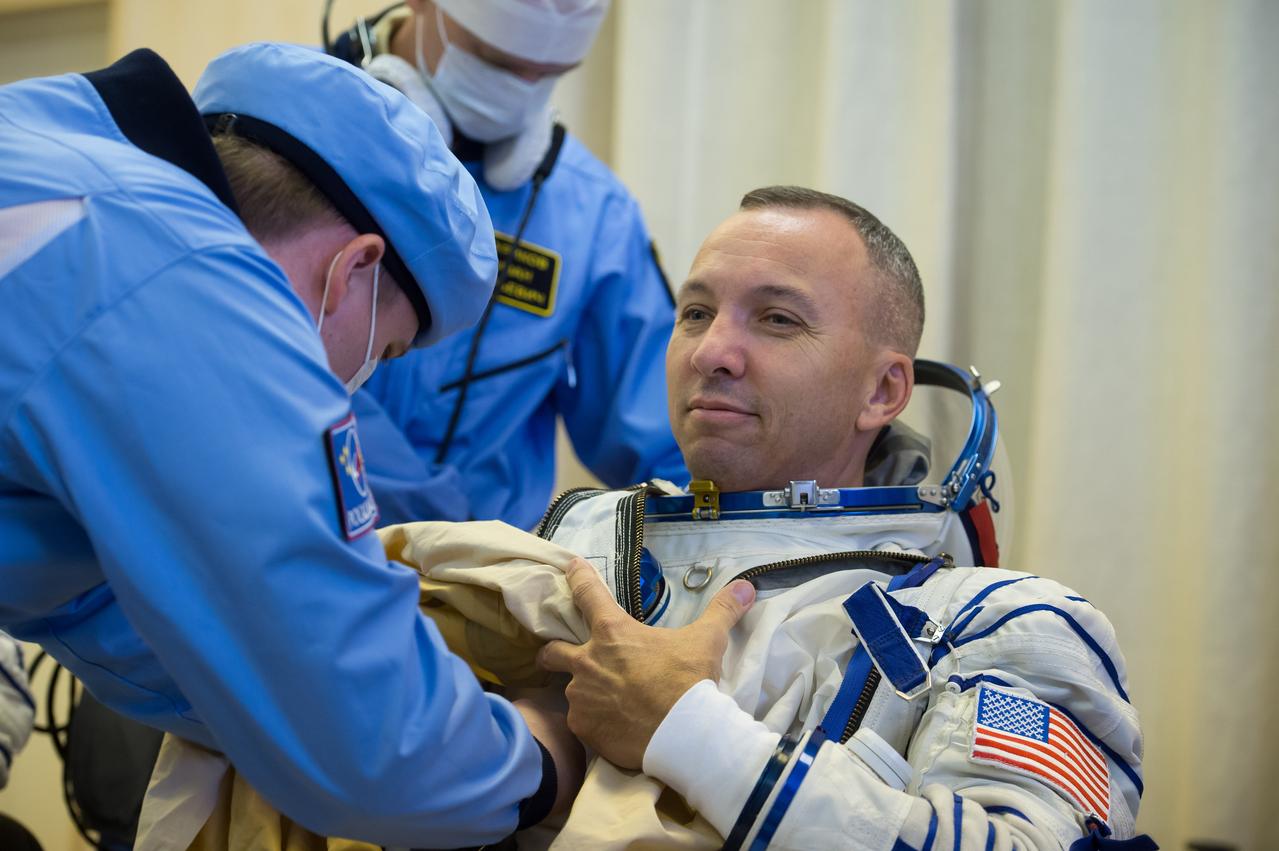 jsc2017e096658 (July 17, 2017) --- In the Integration Facility at the Baikonur Cosmodrome in Kazakhstan, Expedition 52-53 crewmember Randy Bresnik of NASA suits up in his Russian Sokol launch and entry suit during a fit check dress rehearsal July 17. Bresnik, Sergey Ryazanskiy of the Russian Federal Space Agency (Roscosmos) and Paolo Nespoli of the European Space Agency will launch July 28 on the Soyuz MS-05 spacecraft for a five-month mission on the International Space Station. Credit: Andrey Shelepin/Gagarin Cosmonaut Training Center