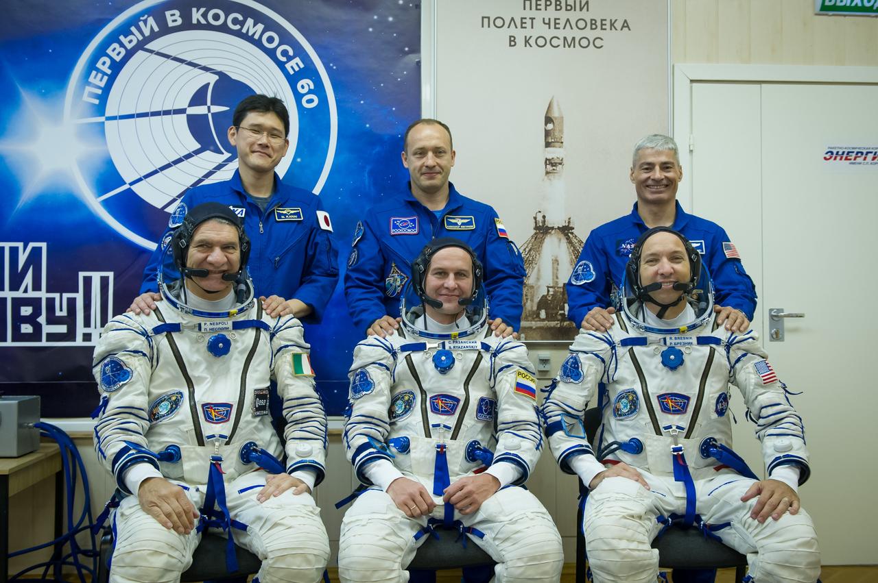 jsc2017e096670 (July 17, 2017) --- In the Integration Facility at the Baikonur Cosmodrome in Kazakhstan, the Expedition 52-53 prime and backup crewmembers pose for pictures July 17 during a fit check dress rehearsal. In the front row are the prime crewmembers, Paolo Nespoli of the European Space Agency (left), Sergey Ryazanskiy of the Russian Federal Space Agency (Roscosmos, center) and Randy Bresnik of NASA (right). In the back row are the backup crew, Norishige Kanai of the Japan Aerospace Exploration Agency (left), Alexander Misurkin of Roscosmos (center) and Mark Vande Hei of NASA (right). Bresnik, Ryazanskiy and Nespoli will launch July 28 on the Soyuz MS-05 spacecraft for a five-month mission on the International Space Station. Credit: Andrey Shelepin/Gagarin Cosmonaut Training Center