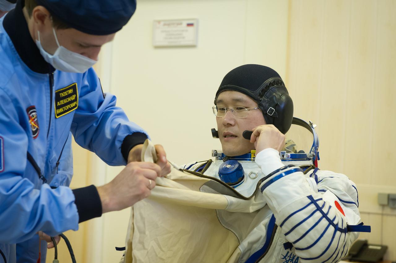 jsc2017e096676 (July 17, 2017) --- In the Integration Facility at the Baikonur Cosmodrome in Kazakhstan, Expedition 52-53 backup crewmember Norishige Kanai of the Japan Aerospace Exploration Agency suits up in his Russian Sokol launch and entry suit July 17 during a fit check dress rehearsal. Kanai, Alexander Misurkin of the Russian Federal Space Agency (Roscosmos) and Mark Vande Hei of NASA are serving as backups to the prime crew, Paolo Nespoli of the European Space Agency, Sergey Ryazanskiy of Roscosmos and Randy Bresnik of NASA, who will launch July 28 on the Soyuz MS-05 spacecraft for a five-month mission on the International Space Station. Credit: Andrey Shelepin/Gagarin Cosmonaut Training Center