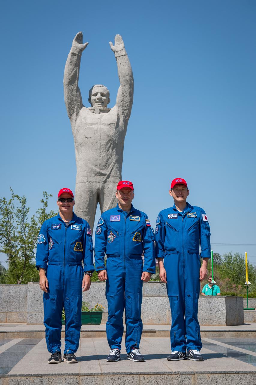 jsc2017e100900 (July 18, 2017) --- Expedition 52-53 backup crewmembers Mark Vande Hei of NASA (left), Alexander Misurkin of the Russian Federal Space Agency (Roscosmos, center) and Norishige Kanai of the Japan Aerospace Exploration Agency (JAXA, right) pose for pictures in front of the statue of Yuri Gagarin, the first human in space, in the town of Baikonur, Kazakhstan July 18 during traditional pre-launch ceremonies. They are serving as backups to Randy Bresnik of NASA, Sergey Ryazanskiy of Roscosmos and Paolo Nespoli of the European Space Agency, who will launch July 28 on the Soyuz MS-05 spacecraft from the Baikonur Cosmodrome for a five-month mission on the International Space Station. Credit: NASA/Victor Zelentsov