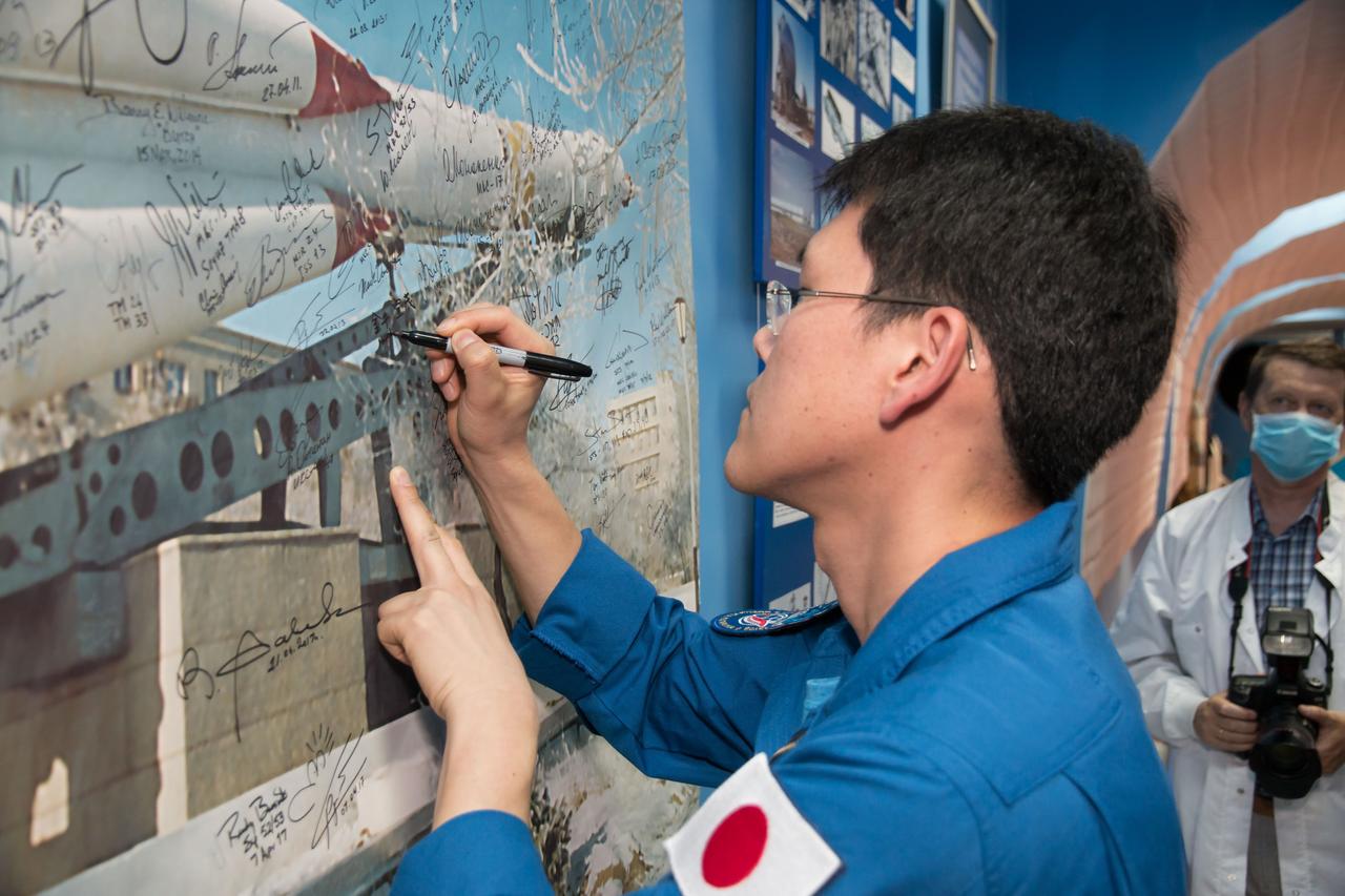 jsc2017e100906 (July 18, 2017) --- Expedition 52-53 backup crewmember Norishige Kanai of the Japan Aerospace Exploration Agency (JAXA) signs a mural in a space museum in Baikonur, Kazakhstan July 18 during traditional pre-launch ceremonies. Kanai, Alexander Misurkin of the Russian Federal Space Agency (Roscosmos) and Mark Vande Hei of NASA are serving as backups to Sergey Ryazanskiy of Roscosmos, Randy Bresnik of NASA and Paolo Nespoli of the European Space Agency, who will launch July 28 on the Soyuz MS-05 spacecraft from the Baikonur Cosmodrome for a five-month mission on the International Space Station. Credit: NASA/Victor Zelentsov
