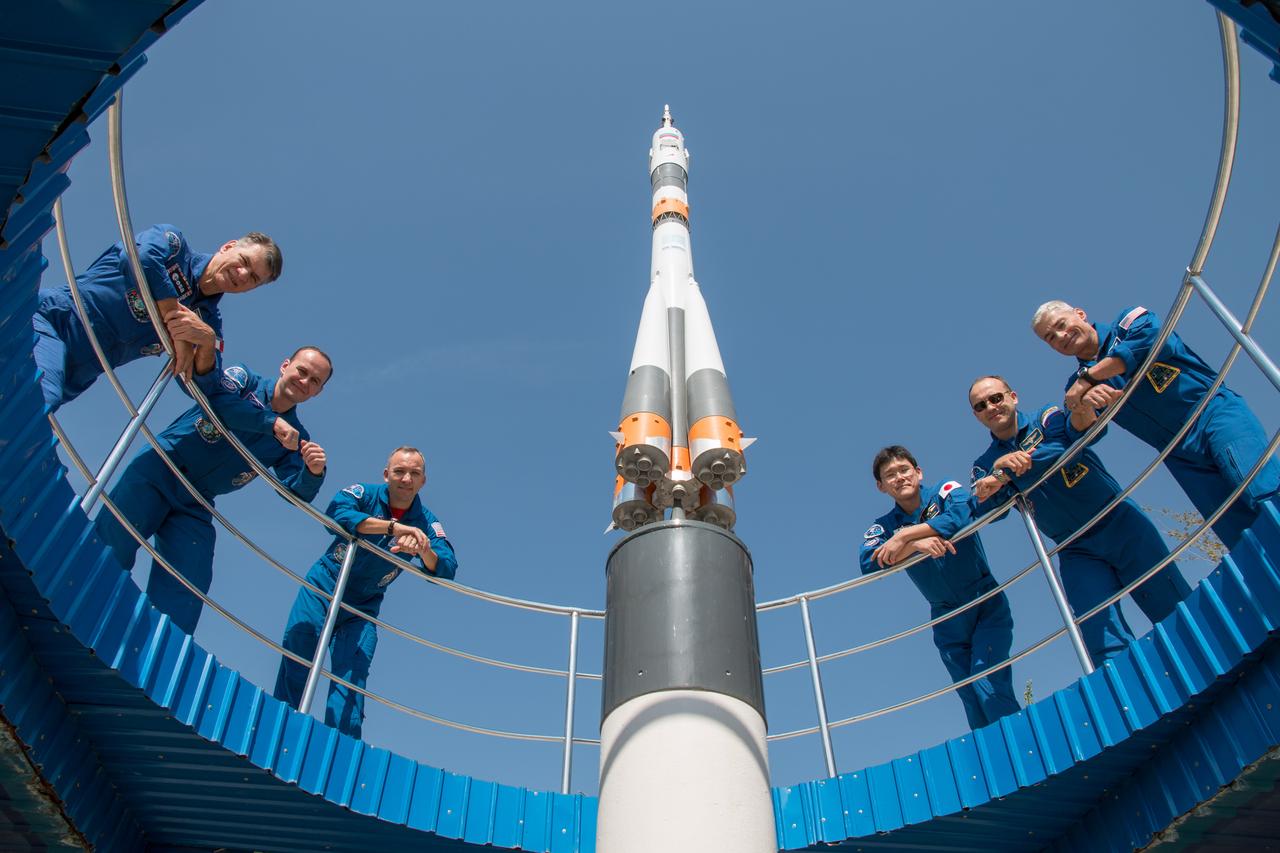 jsc2017e101939 (July 22, 2017) --- From a unique perspective at the Cosmonaut Hotel crew quarters in Baikonur, Kazakhstan, the Expedition 52-53 backup and prime crewmembers pose for pictures July 22 in the midst of pre-launch training. From left to right are the prime crewmembers, Paolo Nespoli of the European Space Agency, Sergey Ryazanskiy of the Russian Federal Space Agency (Roscosmos) and Randy Bresnik of NASA, and the backup crewmembers, Norishige Kanai of the Japan Aerospace Exploration Agency (JAXA), Alexander Misurkin of Roscosmos and Mark Vande Hei of NASA. Ryazanskiy, Bresnik and Nespoli will launch July 28 on the Soyuz MS-05 spacecraft from the Baikonur Cosmodrome for a five-month mission on the International Space Station. Credit: NASA/Victor Zelentsov