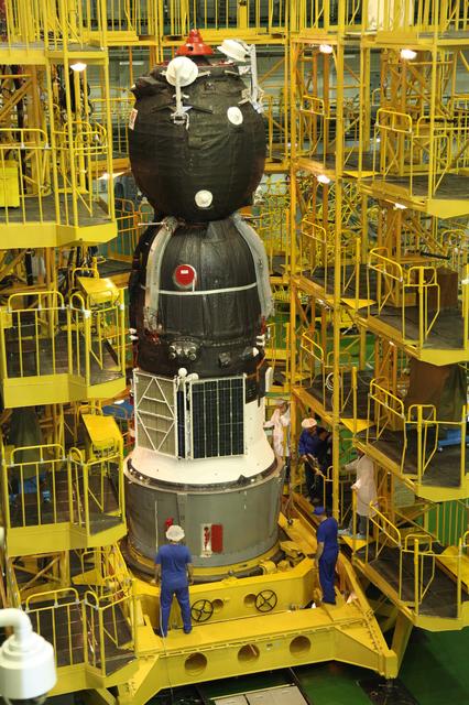 jsc2017e101953 (July 22, 2017) --- In the Integration Facility at the Baikonur Cosmodrome in Kazakhstan, the Soyuz MS-05 spacecraft stands poised to be encapsulated in the upper stage of a Soyuz booster July 21 in preparation for its launch. Expedition 52-53 crewmembers Sergey Ryazanskiy of the Russian Federal Space Agency (Roscosmos), Randy Bresnik of NASA and Paolo Nespoli of the European Space Agency will launch July 28 on the Soyuz MS-05 for a five-month mission on the International Space Station. Credit: Roscosmos
