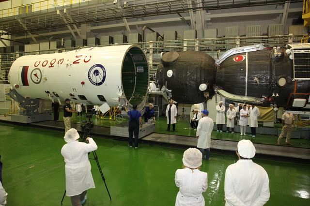 jsc2017e101957 (July 22, 2017) --- In the Integration Facility at the Baikonur Cosmodrome in Kazakhstan, the Soyuz MS-05 spacecraft is encapsulated in the upper stage of a Soyuz booster July 21 in preparation for its launch. Expedition 52-53 crewmembers Sergey Ryazanskiy of the Russian Federal Space Agency (Roscosmos), Randy Bresnik of NASA and Paolo Nespoli of the European Space Agency will launch July 28 on the Soyuz MS-05 for a five-month mission on the International Space Station. Credit: Roscosmos