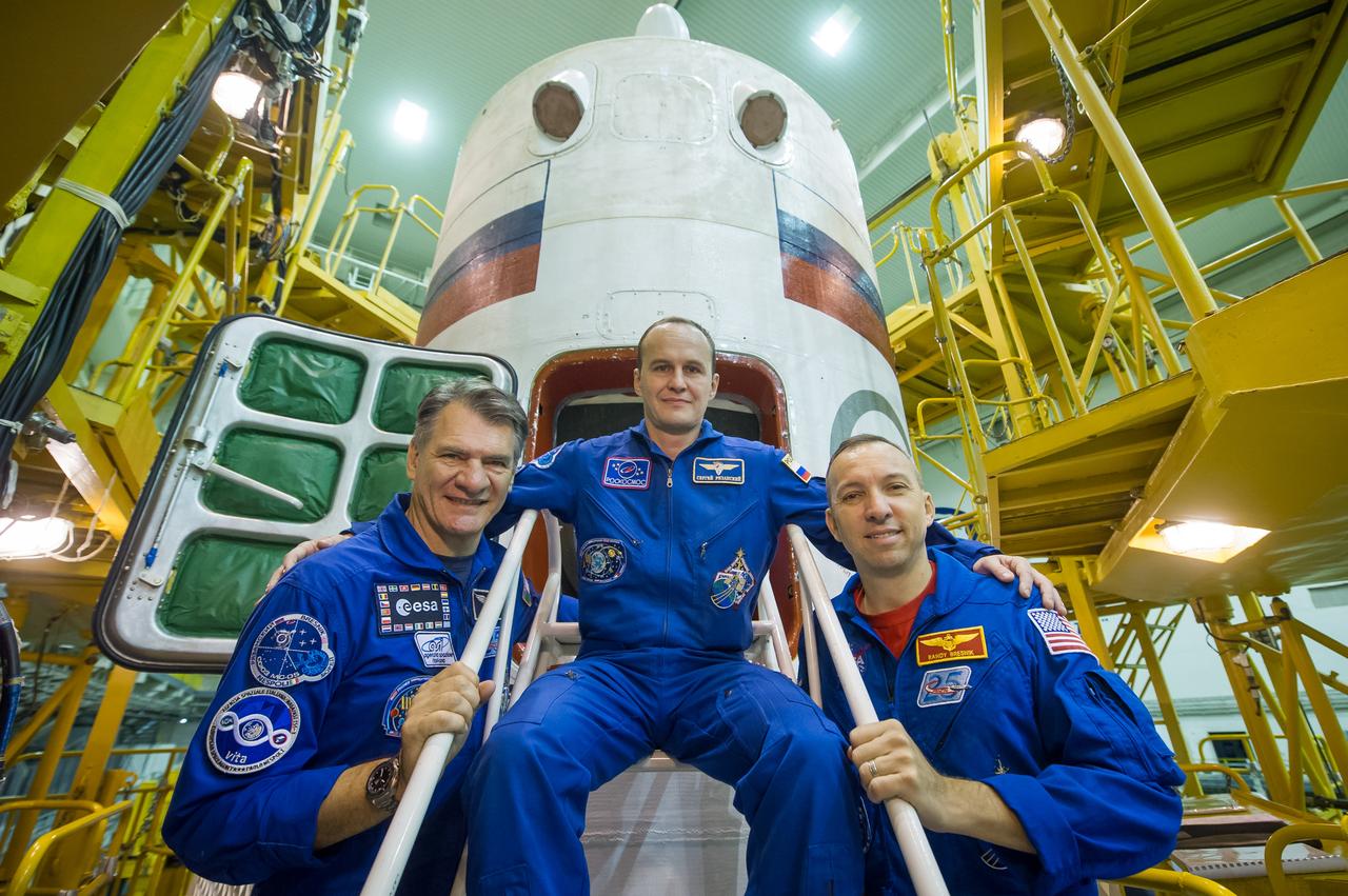 jsc2017e101959 (July 22, 2017) --- In the Integration Facility at the Baikonur Cosmodrome in Kazakhstan, Expedition 52-53 crewmembers Paolo Nespoli of the European Space Agency (left), Sergey Ryazanskiy of the Russian Federal Space Agency (Roscosmos, center) and Randy Bresnik of NASA (right) pose for pictures in front of the Soyuz MS-05 spacecraft July 24 during their final fit check dress rehearsal. They will launch July 28 aboard the Soyuz MS-05 spacecraft for a five-month mission on the International Space Station. Credit: Andrey Shelepin/Gagarin Cosmonaut Training Center