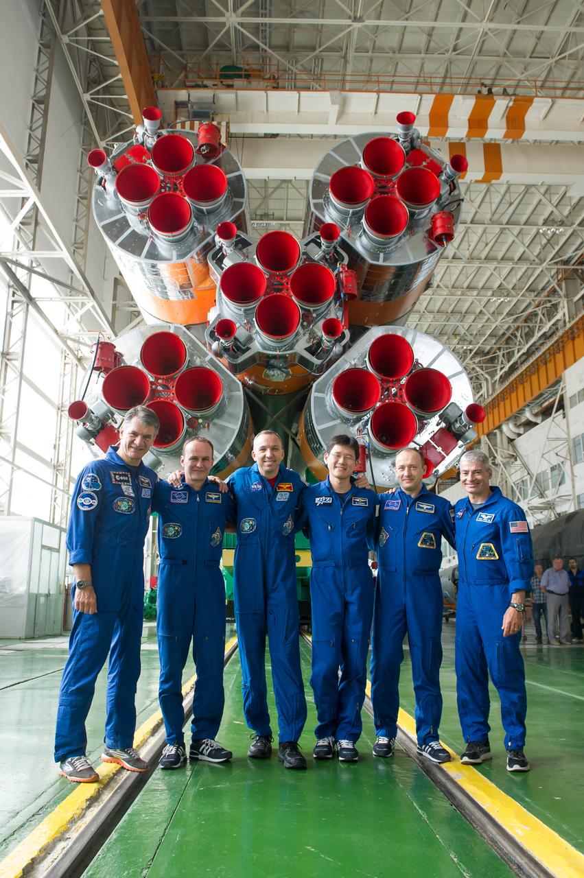 jsc2017e101962 (July 22, 2017) --- In the Integration Facility at the Baikonur Cosmodrome in Kazakhstan, the Expedition 52-53 prime and backups crews pose for pictures in front of the first stage engines of the Soyuz booster rocket July 24 as part of their final fit check dress rehearsal. From left to right are prime crewmembers Paolo Nespoli of the European Space Agency, Sergey Ryazanskiy of the Russian Federal Space Agency (Roscosmos) and Randy Bresnik of NASA and backup crewmembers Norishige Kanai of the Japan Aerospace Exploration Agency (JAXA), Alexander Misurkin of Roscosmos and Mark Vande Hei of NASA. Nespoli, Bresnik and Ryazanskiy will launch July 28 aboard the Soyuz MS-05 spacecraft for a five-month mission on the International Space Station. Credit: Andrey Shelepin/Gagarin Cosmonaut Training Center