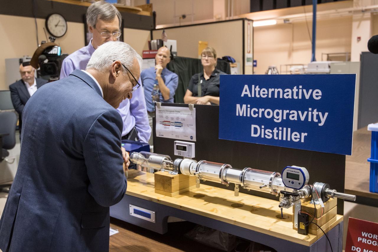 NASA Chief Technologist Douglas Terrier inspects Jacobs’ mockup of the on-orbit Alpha Magnetic Spectrometer hardware. Astronauts use the mockup hardware to train on the ground to prepare to perform operations on the International Space Station. Jacobs provides advanced technologies used aboard the International Space Station and for deep space exploration.  Date: 08-10-2017 Location: B1 & Jacobs Engineering Subject: NASA Acting Chief Technology Officer Douglas Terrier Tours JSC and Jacobs Photographer: David DeHoyos