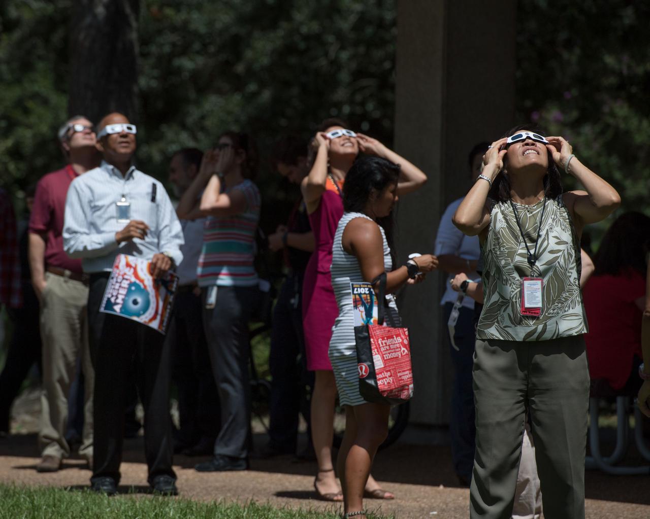 jsc2017e110798 (Aug. 21, 2017) --- Employees at NASA’s Johnson Space Center in Houston joined the rest of the country in experiencing the 2017 eclipse on Aug. 21, 2017. Many used protective eclipse glasses, and others made use of manufactured or pin-hole cameras of opportunity to view the eclipse. In Houston, the partial eclipse duration was 2 hours, 59 minutes, reaching its maximum level of 67 percent at 1:17 p.m. CDT. Some members of the team supporting the International Space Station in the Christopher C. Kraft Mission Control Center took advantage of a break in their duties to step outside the windowless building to witness what their colleagues in orbit also saw and documented with a variety of cameras.