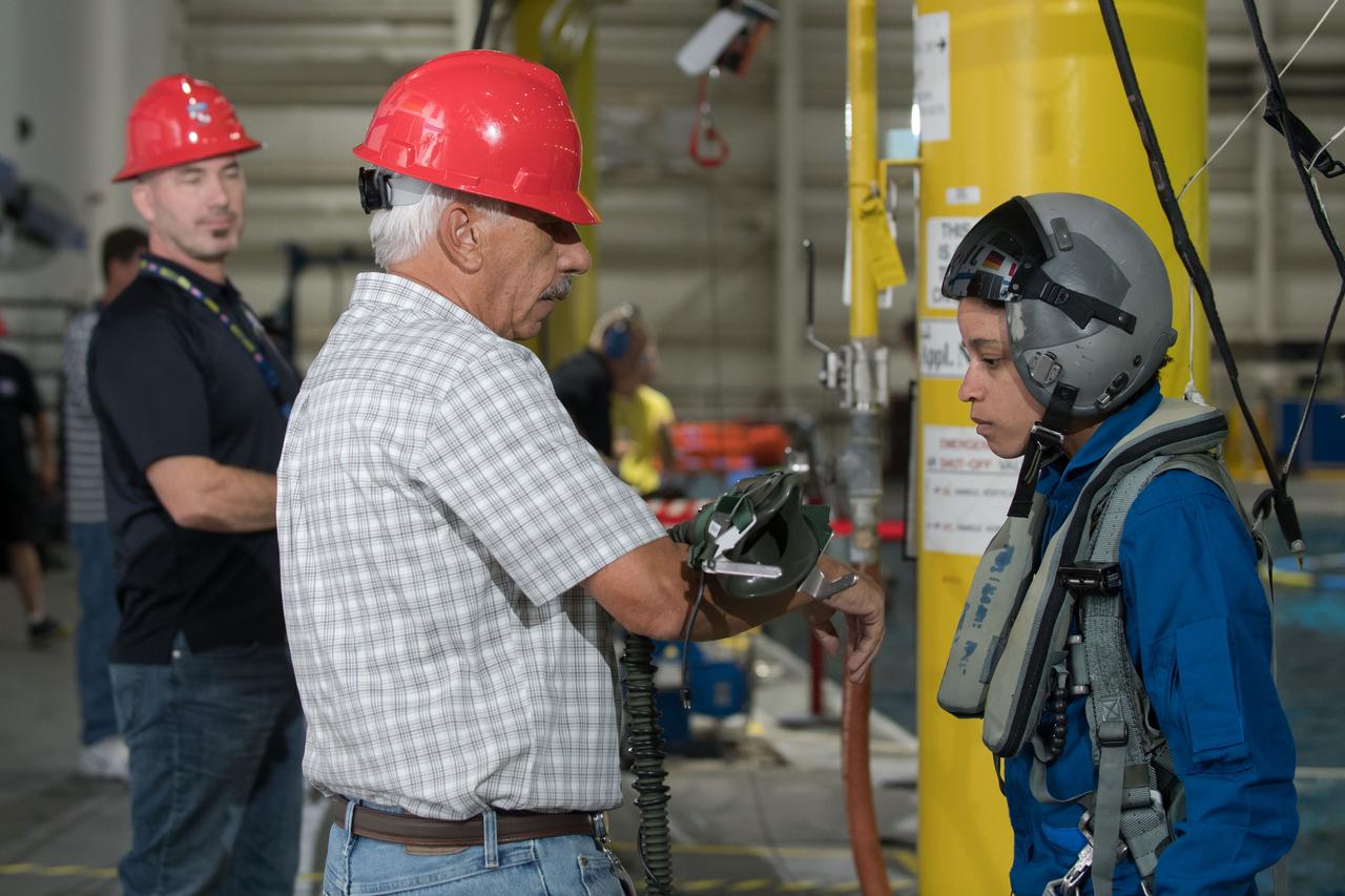 jsc2017e111790 (08-23-2017) --- During water survival training in 2017 at NASA Johnson Space Center’s Neutral Buoyancy Laboratory in Houston, NASA astronaut candidate Jessica Watkins (right) works alongside instructors. Photo Credit: (NASA/David DeHoyos)