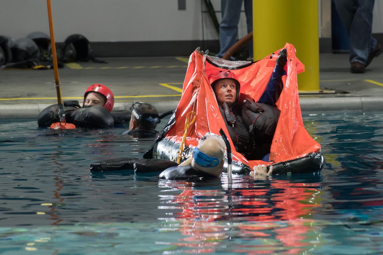 jsc2017e1117836 (08-23-2017) --- During water survival training in 2017 at NASA Johnson Space Center’s Neutral Buoyancy Laboratory in Houston, NASA astronaut candidate Zena Cardman (foreground) and Warren Hoburg (background) work alongside divers. Photo Credit: (NASA/David DeHoyos)