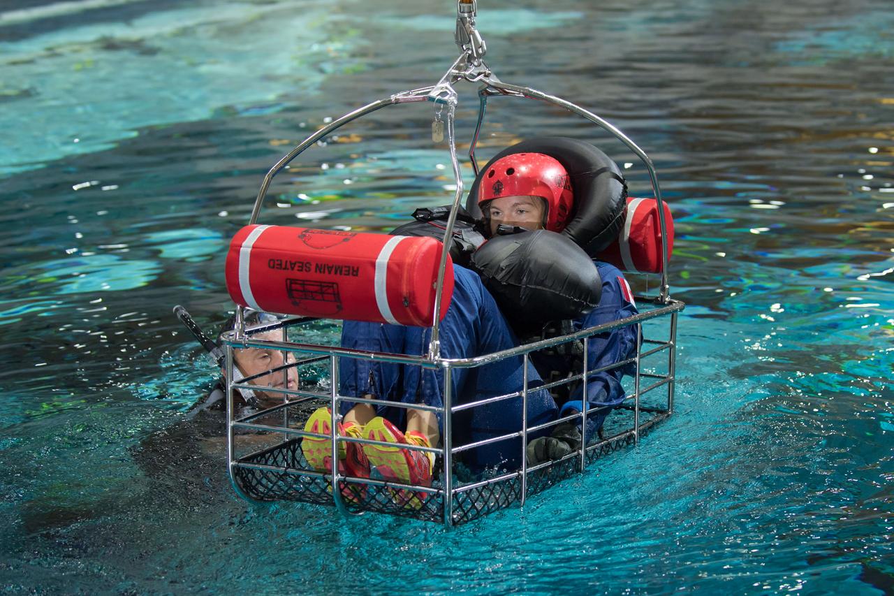 jsc2017e1117871 (08-23-2017) --- During water survival training in 2017 at NASA Johnson Space Center’s Neutral Buoyancy Laboratory in Houston, Canadian Space Agency astronaut candidate  Jennifer Sidey-Gibbons is guided through training by divers. Photo Credit: (NASA/David DeHoyos)