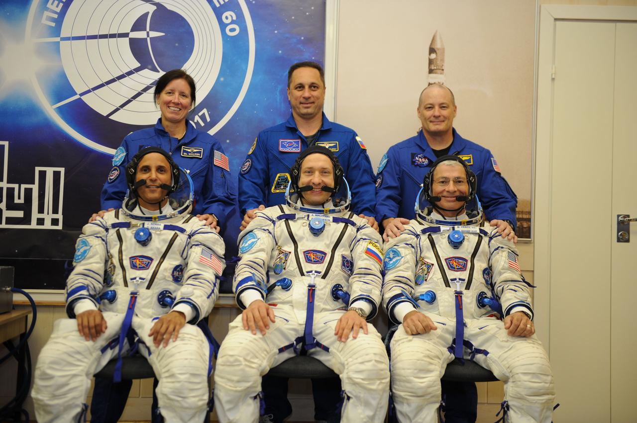 jsc2017e114472 (Aug. 28, 2017) --- In the Integration Facility at the Baikonur Cosmodrome in Kazakhstan, the Expedition 53-54 prime and backup crewmembers pose for pictures Aug. 28 during pre-launch training activities. Clad in their Sokol launch and entry suits in the front row are the prime crewmembers, Joe Acaba of NASA (left), Alexander Misurkin of Roscosmos (center) and Mark Vande Hei of NASA (right). Behind them are their backups, Shannon Walker of NASA (left), Anton Shkaplerov of Roscosmos (center) and Scott Tingle of NASA (left). Acaba, Vande Hei of NASA and Misurkin will launch Sept. 13 on the Soyuz MS-06 spacecraft for a five and a half month mission on the International Space Station. Credit: Gagarin Cosmonaut Training Center/Irina Peshkova