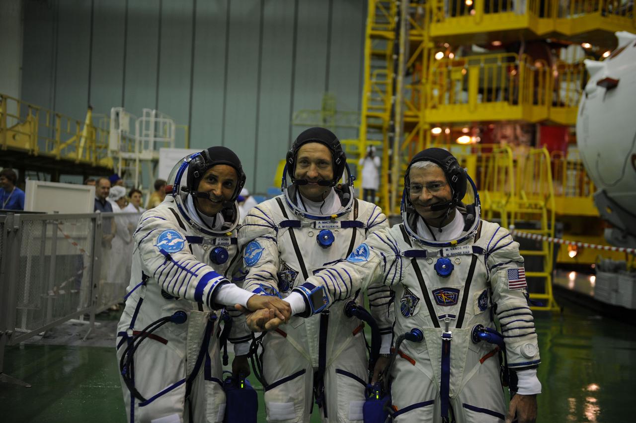 jsc2017e114473 (Aug. 28, 2017) --- In the Integration Facility at the Baikonur Cosmodrome in Kazakhstan, the Expedition 53-54 crewmembers pose for pictures Aug. 28 during pre-launch training activities. Joe Acaba of NASA (left), Alexander Misurkin of Roscosmos (center) and Mark Vande Hei of NASA (right) will launch Sept. 13 on the Soyuz MS-06 spacecraft for a five and a half month mission on the International Space Station. Credit: Gagarin Cosmonaut Training Center/Irina Peshkova
