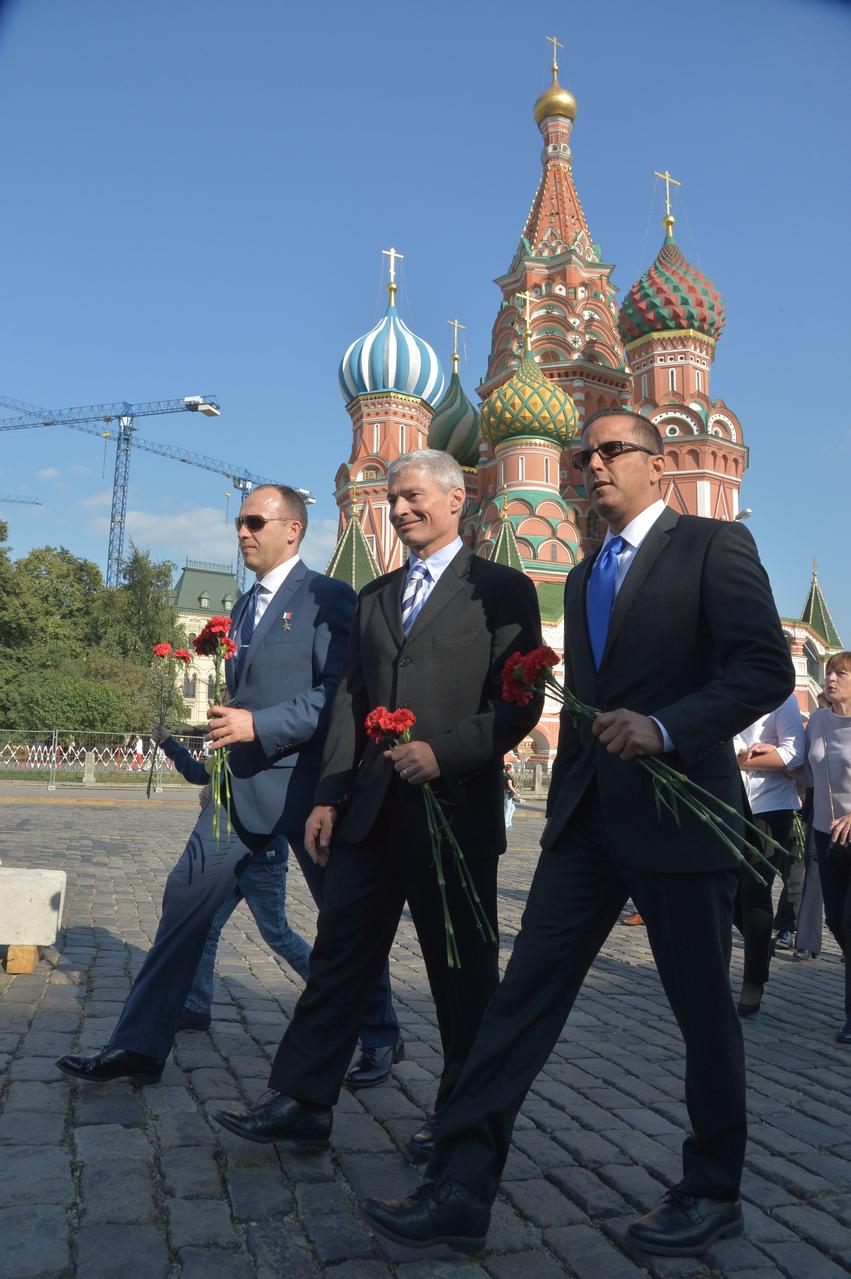 jsc2017e114484 (Sept. 1, 2017) --- Expedition 53-54 crewmembers Alexander Misurkin of Roscosmos (left) and Mark Vande Hei (center) and Joe Acaba of NASA (right) walk through Red Square in Moscow in front of St. Basil’s Cathedral Sept. 1 as they prepared to lay flowers at the Kremlin Wall where Russian space icons are interred in traditional pre-launch ceremonies. They will launch Sept. 13 from the Baikonur Cosmodrome in Kazakhstan Sept. 13 on the Soyuz MS-06 spacecraft for a five and a half month mission on the International Space Station. Credit: NASA/Elizabeth Weissinger