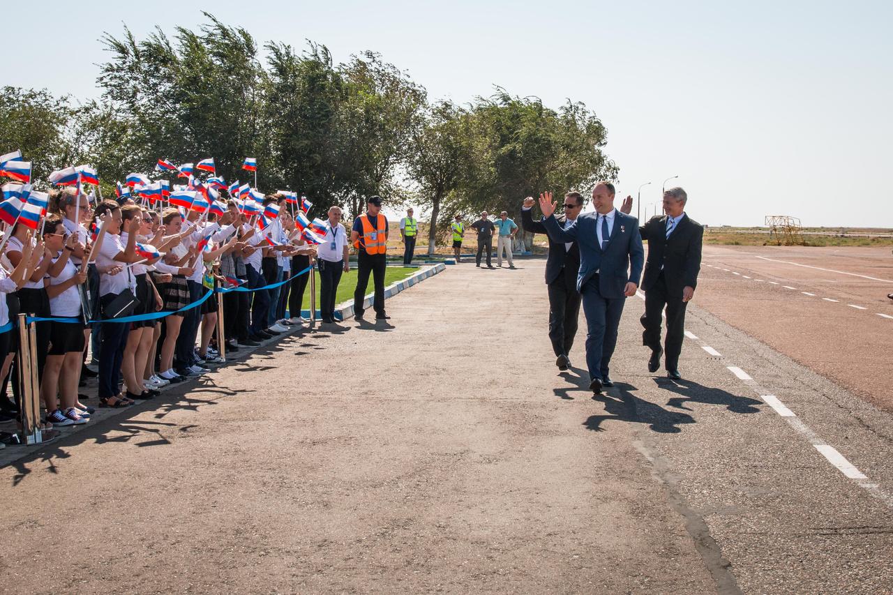 jsc2017e114751 (Sept. 6, 2017) --- Expedition 53-54 crewmembers Joe Acaba of NASA (left), Alexander Misurkin of Roscosmos (center) and Mark Vande Hei of NASA (right) are greeted by local students after arriving at their launch site at the Baikonur Cosmodrome in Kazakhstan Sept. 6 following a flight from their training base in Star City, Russia for final pre-launch training. They will launch Sept. 13 on the Soyuz MS-06 spacecraft from the Baikonur Cosmodrome for a five and a half month mission on the International Space Station. Credit: NASA/Victor Zelentsov