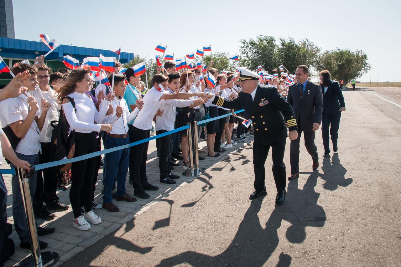 jsc2017e114752 (Sept. 6, 2017) --- Expedition 53-54 backup crewmembers Scott Tingle of NASA (foreground), Anton Shkaplerov of Roscosmos (center), and Shannon Walker of NASA are greeted by local students after arriving at the launch site at the Baikonur Cosmodrome in Kazakhstan Sept. 6 after a flight from their training base in Star City, Russia for final pre-launch training. They are serving as backups to the prime crew, Alexander Misurkin of Roscosmos and Joe Acaba and Mark Vande Hei of NASA, who will launch Sept. 13 on the Soyuz MS-06 spacecraft from the Baikonur Cosmodrome for a five and a half month mission on the International Space Station. Credit: NASA/Victor Zelentsov