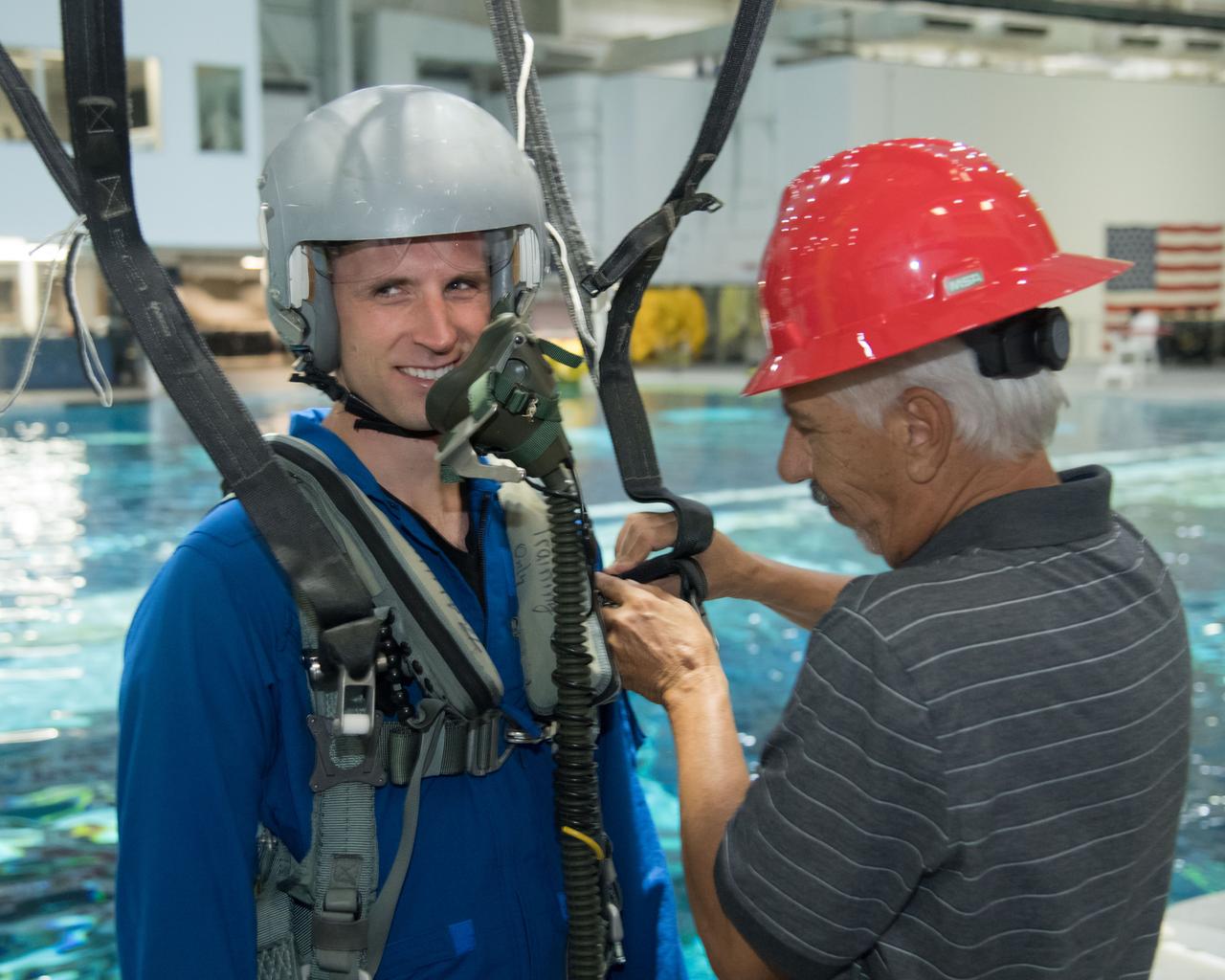 jsc2017e114912 (09-06-17) --- During water survival training in 2017 at NASA Johnson Space Center’s Neutral Buoyancy Laboratory in Houston, Canadian Space Agency astronaut candidate Joshua Kutryk is fitted for training gear by  instructors. Photo Credit: (NASA/James Blair)