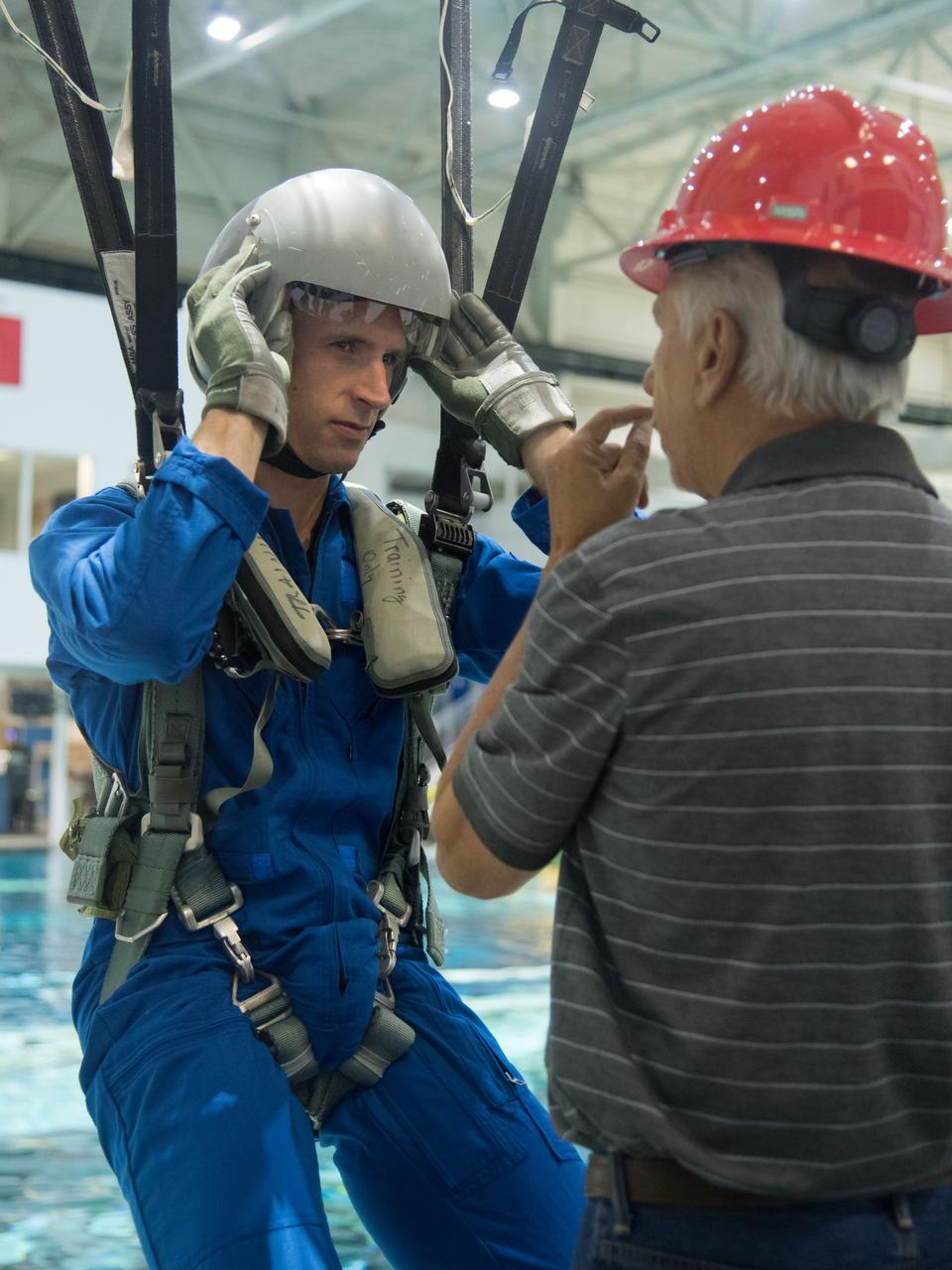 jsc2017e114915 (09-06-17) --- During water survival training in 2017 at NASA Johnson Space Center’s Neutral Buoyancy Laboratory in Houston, Canadian Space Agency astronaut candidate Joshua Kutryk is guided through training by  instructors. Photo Credit: (NASA/James Blair)