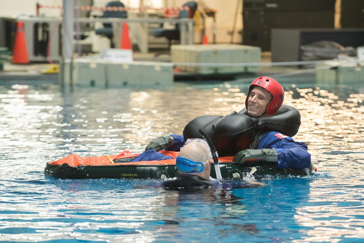 jsc2017e114943 (09-06-17) --- During water survival training in 2017 at NASA Johnson Space Center’s Neutral Buoyancy Laboratory  in Houston,  Canadian Space Agency astronaut candidate Joshua Kutryk is guided through training by divers. Photo Credit: (NASA/James Blair)