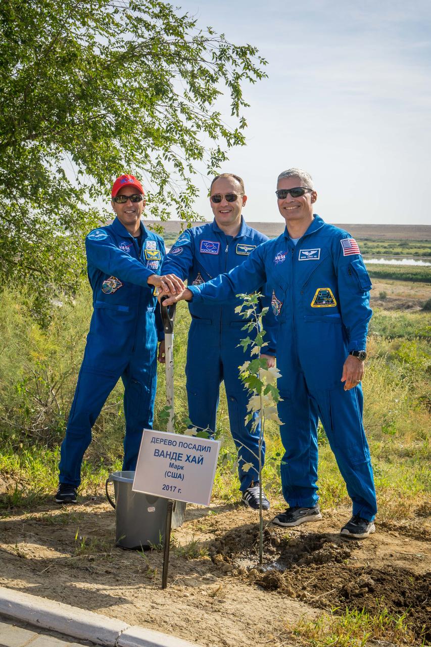 jsc2017e115212 (Sept.. 8, 2017) --- At the Cosmonaut Hotel crew quarters in Baikonur, Kazakhstan, Expedition 53-54 crewmembers Joe Acaba of NASA (left), Alexander Misurkin of Roscosmos (center) and Mark Vande Hei of NASA (right) pose for pictures Sept. 8 after Vande Hei planted a tree bearing his name in a traditional pre-launch ceremony. Acaba, Misurkin and Vande Hei will launch Sept. 13 from the Baikonur Cosmodrome in Kazakhstan on the Soyuz MS-06 spacecraft for a five and a half month mission on the International Space Station. Credit: NASA/Victor Zelentsov