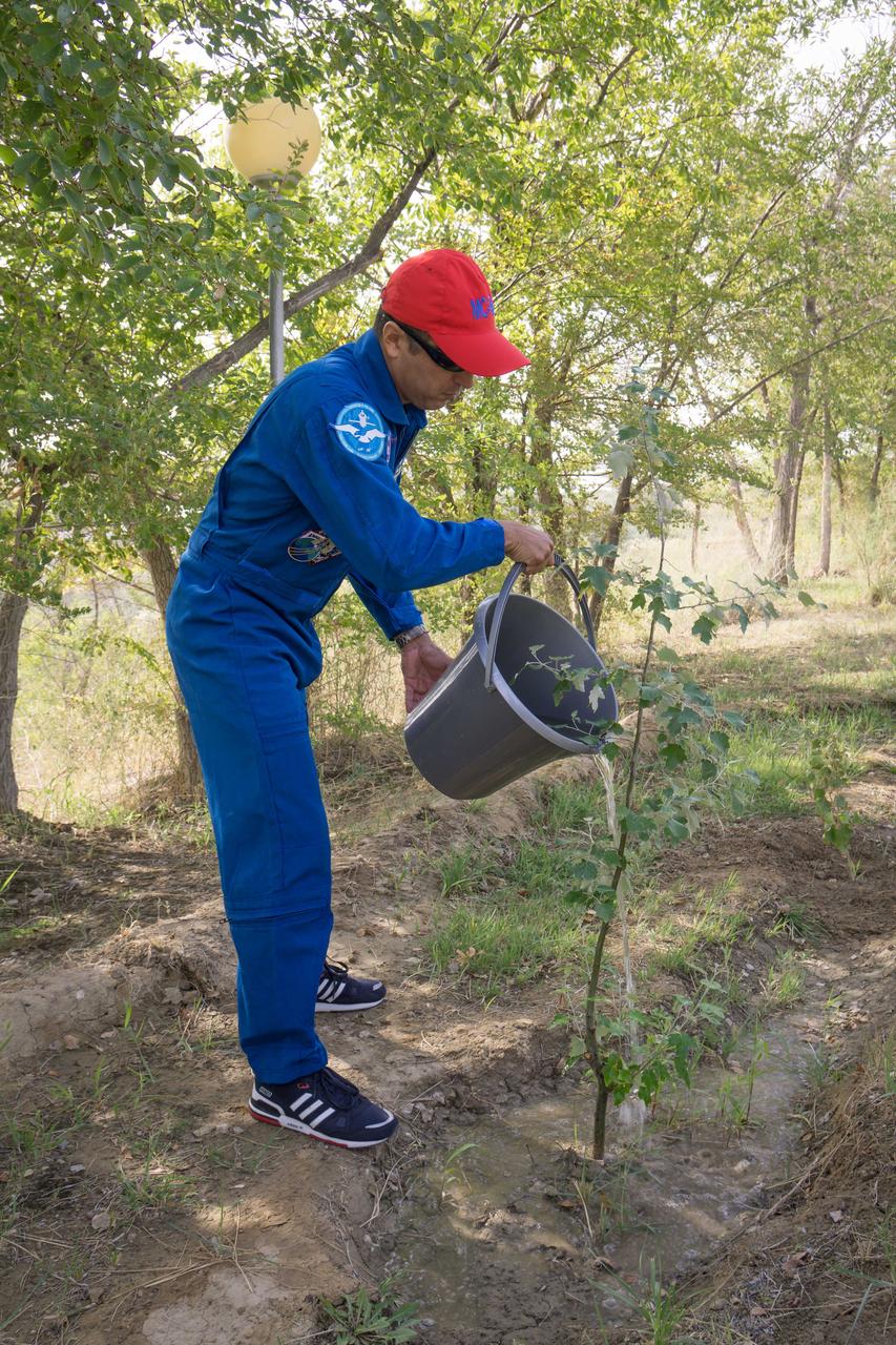 jsc2017e115213 (Sept.. 8, 2017) --- At the Cosmonaut Hotel crew quarters in Baikonur, Kazakhstan, Expedition 53-54 crewmember Joe Acaba of NASA waters a tree bearing his name he previously planted in a traditional pre-launch ceremony Sept. 8. Acaba, Alexander Misurkin of Roscosmos and Mark Vande Hei of NASA will launch Sept. 13 from the Baikonur Cosmodrome in Kazakhstan on the Soyuz MS-06 spacecraft for a five and a half month mission on the International Space Station. Credit: NASA/Victor Zelentsov