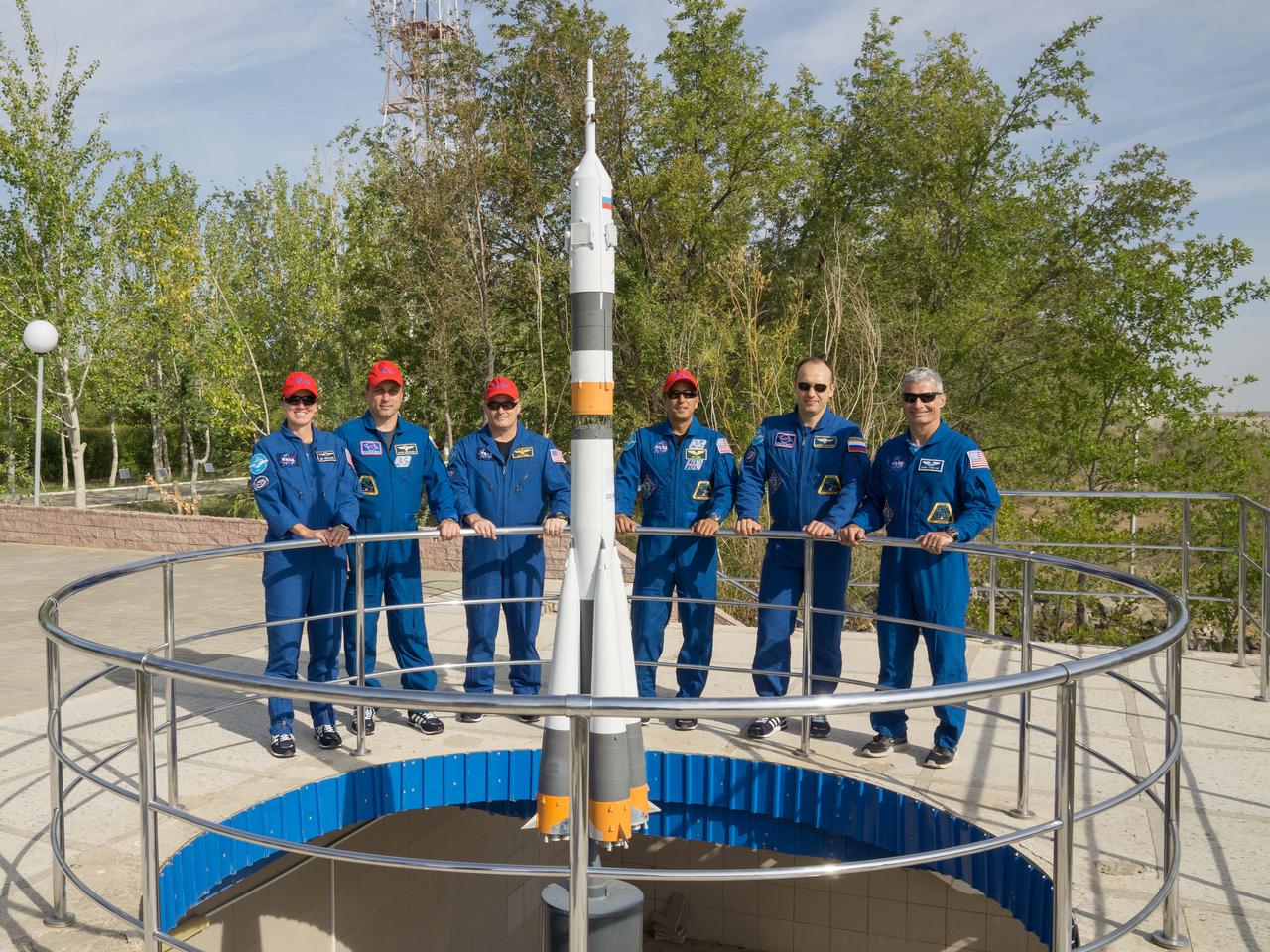 jsc2017e115214 (Sept.. 8, 2017) --- At the Cosmonaut Hotel crew quarters in Baikonur, Kazakhstan, the Expedition 53-54 prime and backup crewmembers pose for photos around a Soyuz rocket mock up Sept. 8 as part of pre-launch activities. From left to right are the backup crewmembers, Shannon Walker of NASA, Anton Shkaplerov of Roscosmos and Scott Tingle of NASA and the prime crewmembers, Joe Acaba of NASA, Alexander Misurkin of Roscosmos and Mark Vande Hei of NASA. Acaba, Misurkin and Vande Hei will launch Sept. 13 from the Baikonur Cosmodrome in Kazakhstan on the Soyuz MS-06 spacecraft for a five and a half month mission on the International Space Station. Credit: NASA/Victor Zelentsov