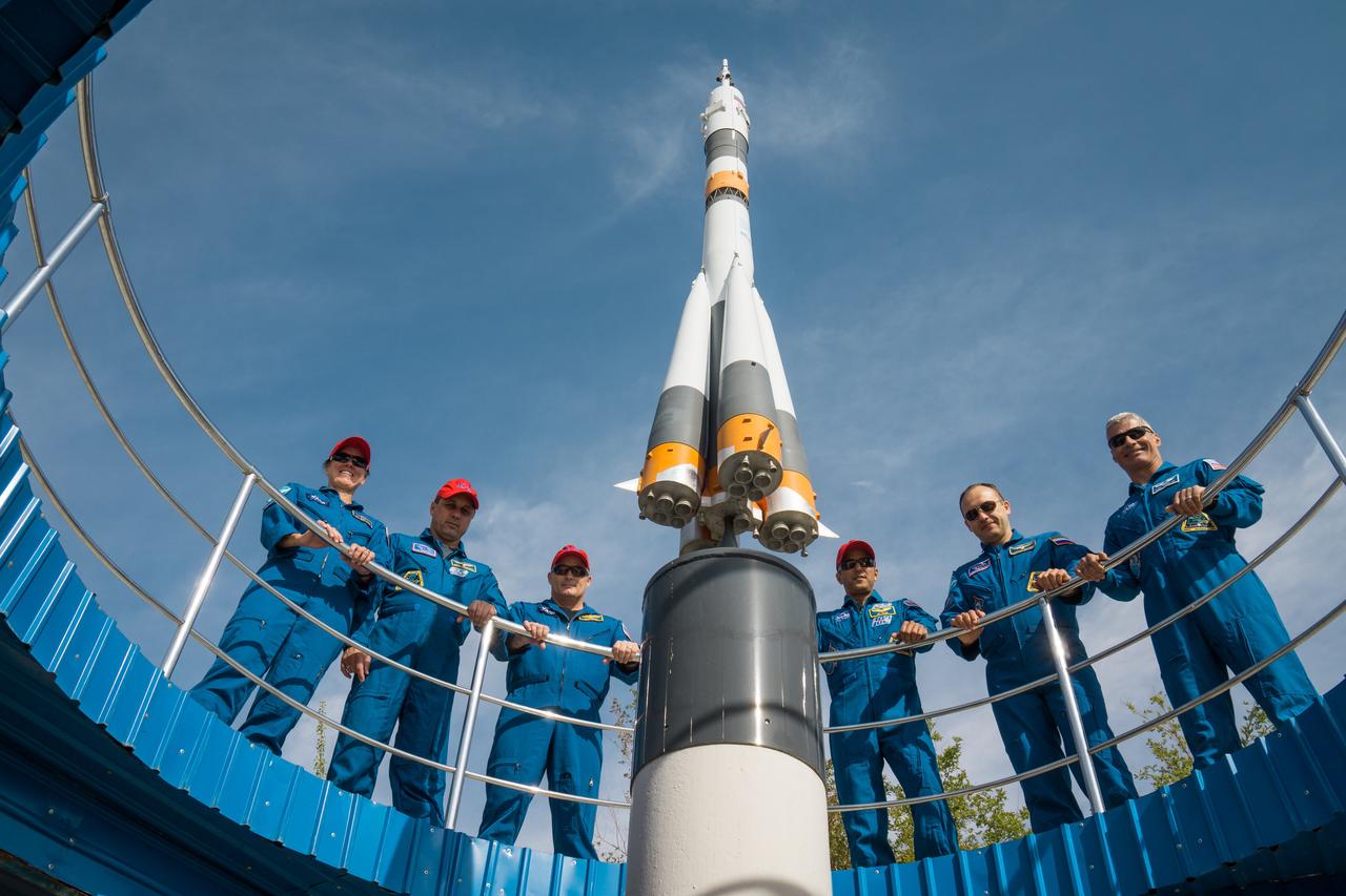 jsc2017e115215 (Sept.. 8, 2017) --- At the Cosmonaut Hotel crew quarters in Baikonur, Kazakhstan, the Expedition 53-54 prime and backup crewmembers pose for photos around a Soyuz rocket mock up Sept. 8 as part of pre-launch activities. From left to right are the backup crewmembers, Shannon Walker of NASA, Anton Shkaplerov of Roscosmos and Scott Tingle of NASA and the prime crewmembers, Joe Acaba of NASA, Alexander Misurkin of Roscosmos and Mark Vande Hei of NASA. Acaba, Misurkin and Vande Hei will launch Sept. 13 from the Baikonur Cosmodrome in Kazakhstan on the Soyuz MS-06 spacecraft for a five and a half month mission on the International Space Station. Credit: NASA/Victor Zelentsov
