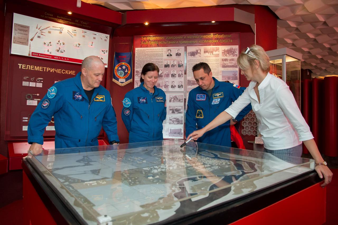 jsc2017e115218 (Sept.. 8, 2017) --- At the Space Museum in the town of Baikonur, Kazakhstan, Expedition 53-54 backup crewmembers Scott Tingle of NASA (left), Shannon Walker of NASA (center) and Anton Shkaplerov of Roscosmos (right) receive a briefing on the layout of the Baikonur Cosmodrome from a museum guide in a traditional pre-launch activity Sept. 8. They are serving as backups to the prime crewmembers, Joe Acaba of NASA, Alexander Misurkin of Roscosmos and Mark Vande Hei of NASA, who will launch on Sept. 13 from the Baikonur Cosmodrome in Kazakhstan on the Soyuz MS-06 spacecraft for a five and a half month mission on the International Space Station. Credit: NASA/Victor Zelentsov