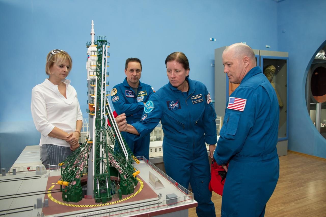 jsc2017e115219 (Sept.. 8, 2017) --- At the Space Museum in the town of Baikonur, Kazakhstan, Expedition 53-54 backup crewmembers Anton Shkaplerov of Roscosmos (second from left), Shannon Walker of NASA (second from right) and Scott Tingle of NASA (right) receive a briefing on a mockup of a Soyuz rocket on its launch pad from a museum guide in a traditional pre-launch activity Sept. 8. They are serving as backups to the prime crewmembers, Joe Acaba of NASA, Alexander Misurkin of Roscosmos and Mark Vande Hei of NASA, who will launch on Sept. 13 from the Baikonur Cosmodrome in Kazakhstan on the Soyuz MS-06 spacecraft for a five and a half month mission on the International Space Station. Credit: NASA/Victor Zelentsov