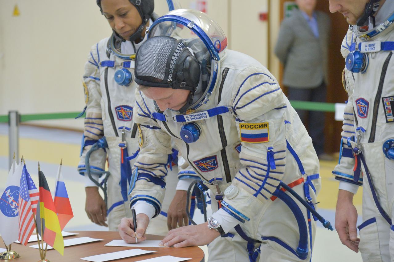 jsc2017e134965 - At the Gagarin Cosmonaut Training Center in Star City, Russia, Expedition 54-55 backup crewmember Sergey Prokopyev of the Russian Federal Space Agency (Roscosmos) signs in for the crew’s final qualification exam activities Nov. 28. Prokopyev, NASA’s Jeanette Epps (left) and Alexander Gerst of the European Space Agency (right) are serving as backups to the prime crew, Anton Shkaplerov of Roscosmos, Scott Tingle of NASA and Norishige Kanai of the Japan Aerospace Exploration Agency (JAXA), who will launch Dec. 17 on their Soyuz MS-07 spacecraft for a five-month mission on the International Space Station...NASA/Elizabeth Weissinger.