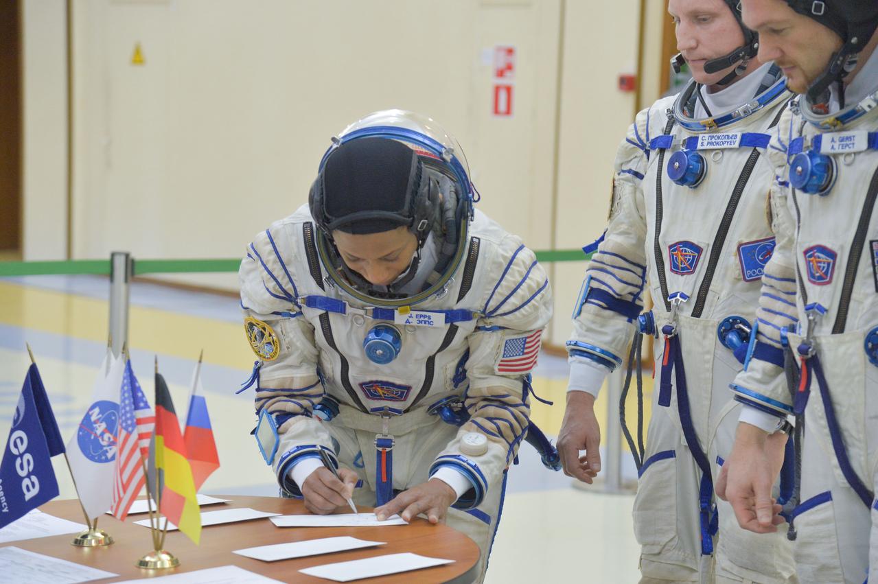 jsc2017e134966 - At the Gagarin Cosmonaut Training Center in Star City, Russia, Expedition 54-55 backup crewmember Jeanette Epps of NASA signs in for the crew’s final qualification exam Nov. 28. Epps, Sergey Prokopyev of the Russian Federal Space Agency (Roscosmos, center) and Alexander Gerst of the European Space Agency (right) are serving as backups to the prime crew, Anton Shkaplerov of Roscosmos, Scott Tingle of NASA and Norishige Kanai of the Japan Aerospace Exploration Agency (JAXA), who will launch Dec. 17 on their Soyuz MS-07 spacecraft for a five-month mission on the International Space Station...NASA/Elizabeth Weissinger